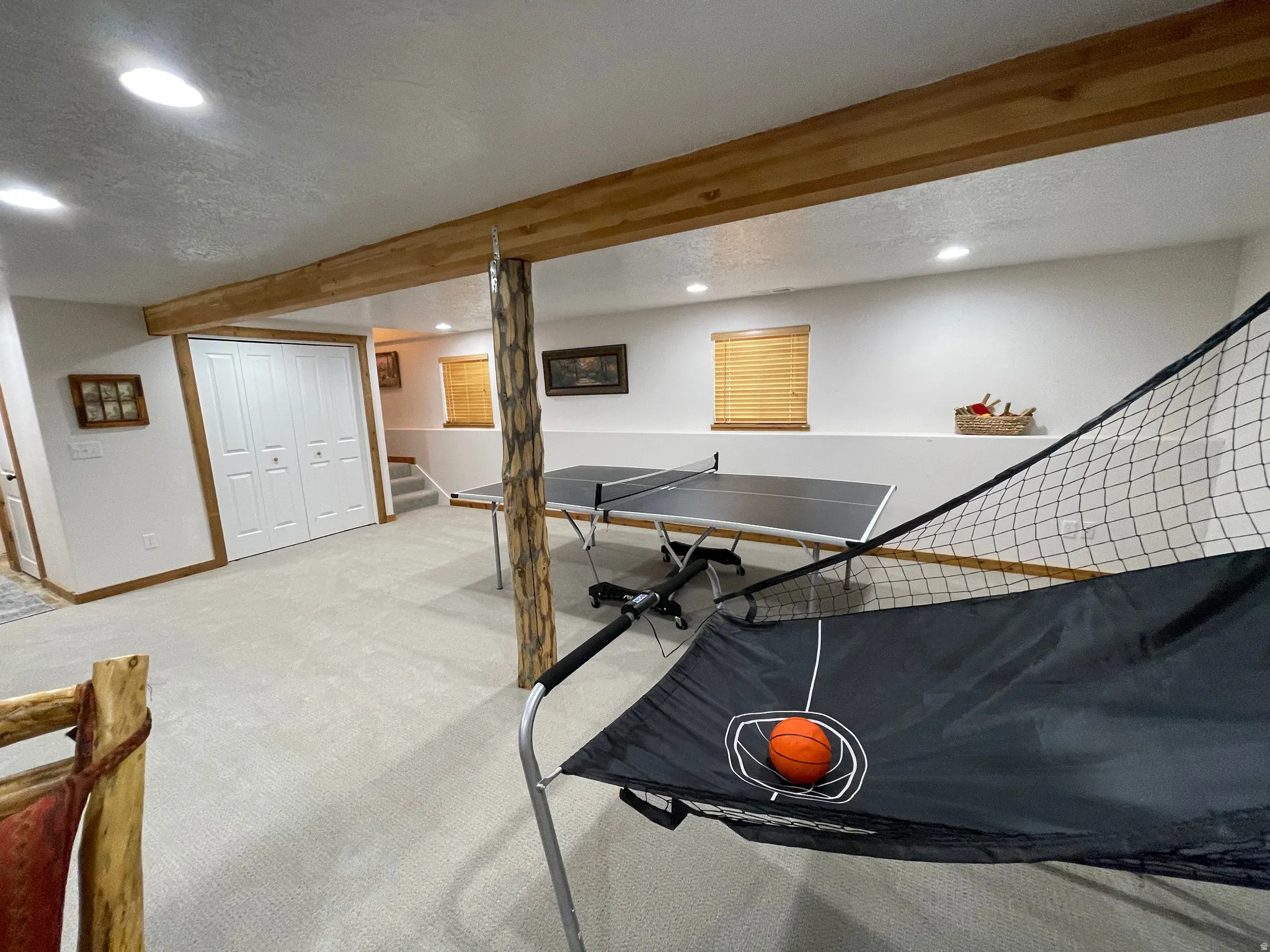 Playroom with a textured ceiling, light carpet, and recessed lighting