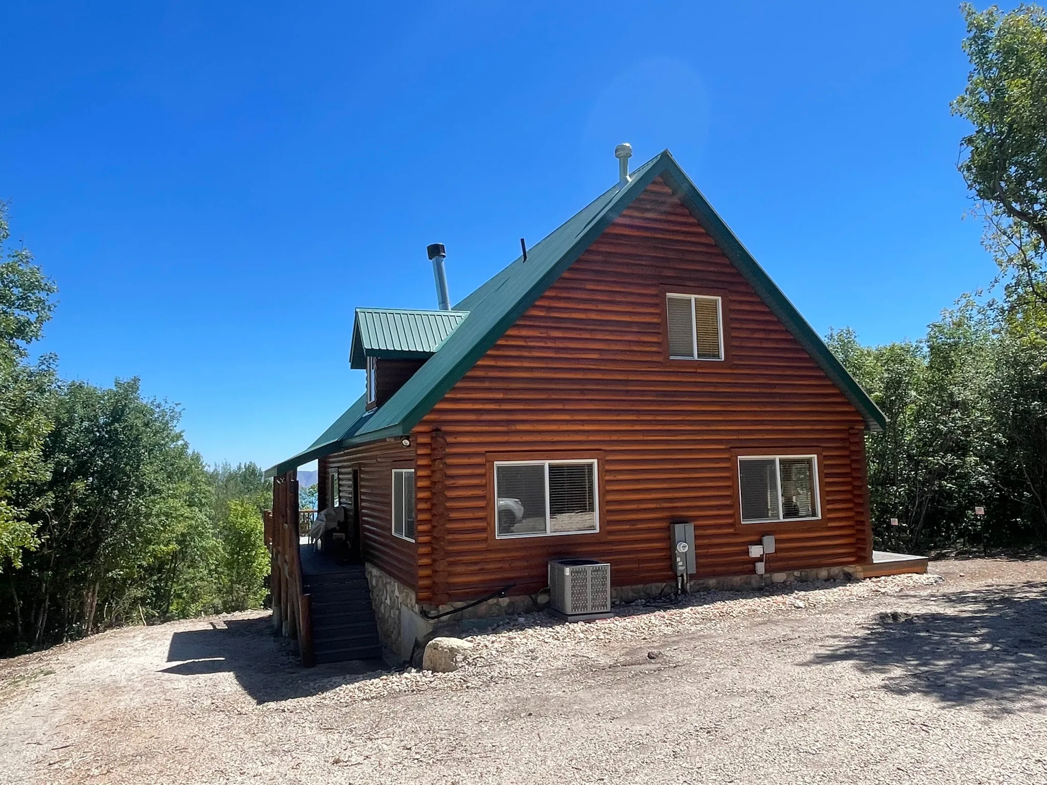 View of side of property featuring log exterior and a metal roof