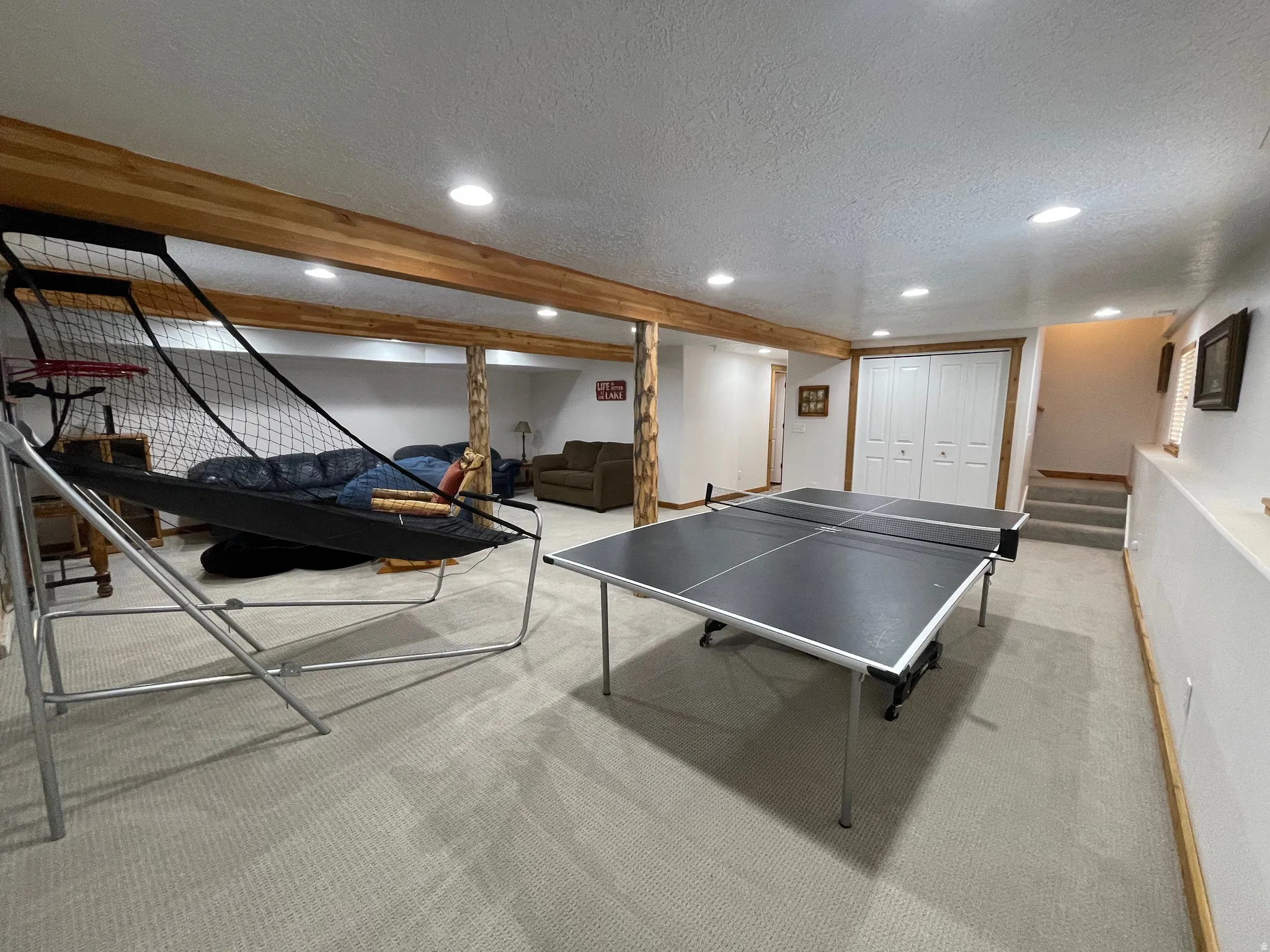 Playroom featuring carpet floors, recessed lighting, and a textured ceiling
