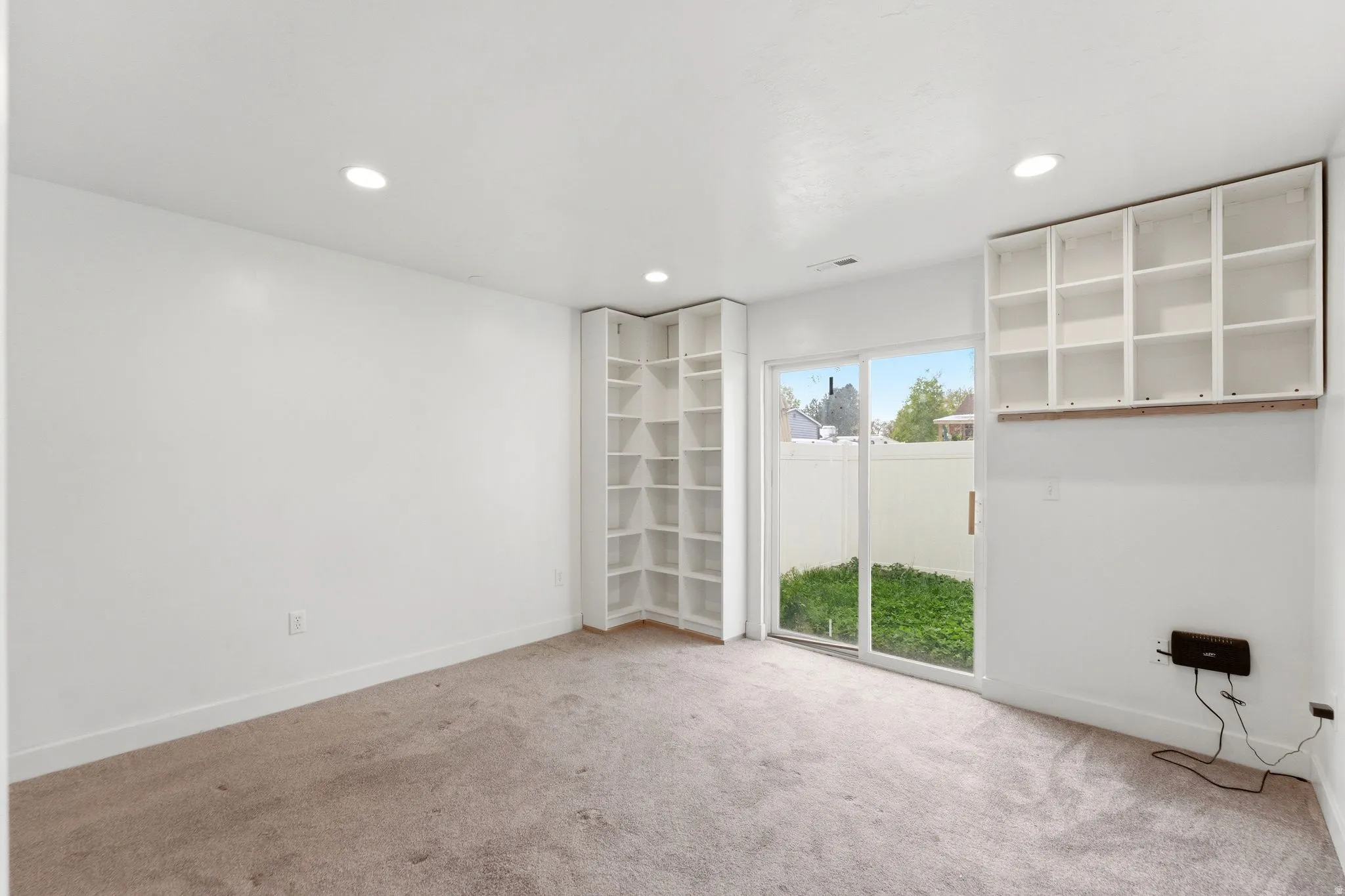 Spare room featuring light colored carpet and recessed lighting