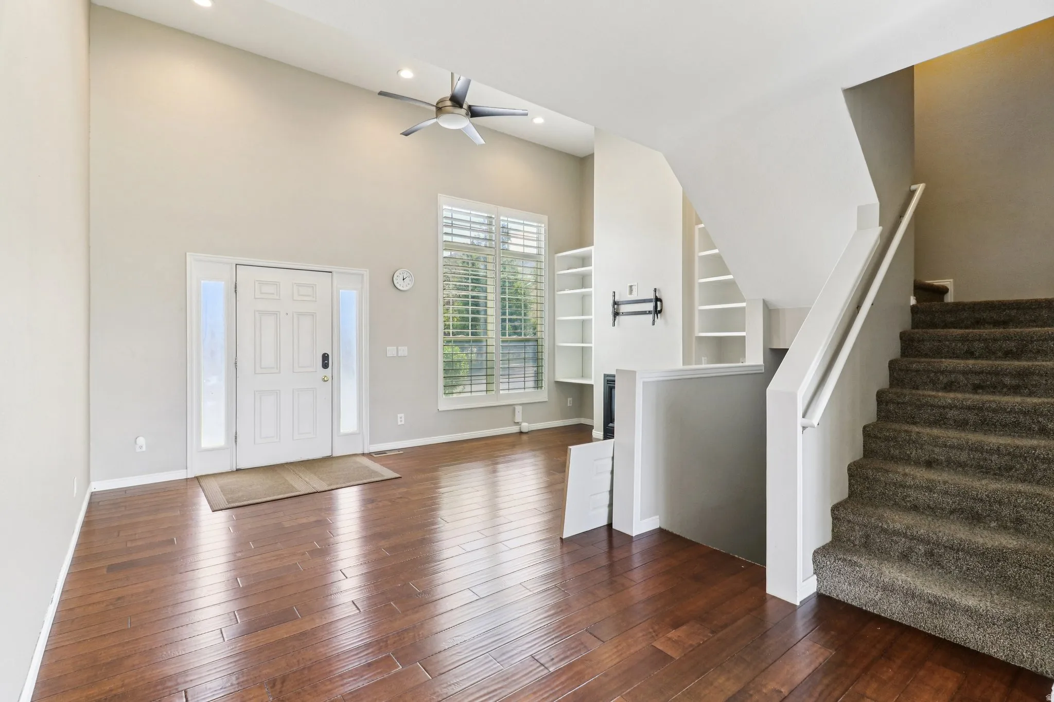 Foyer entrance featuring dark wood finished floors, a high ceiling, ceiling fan, and recessed lighting