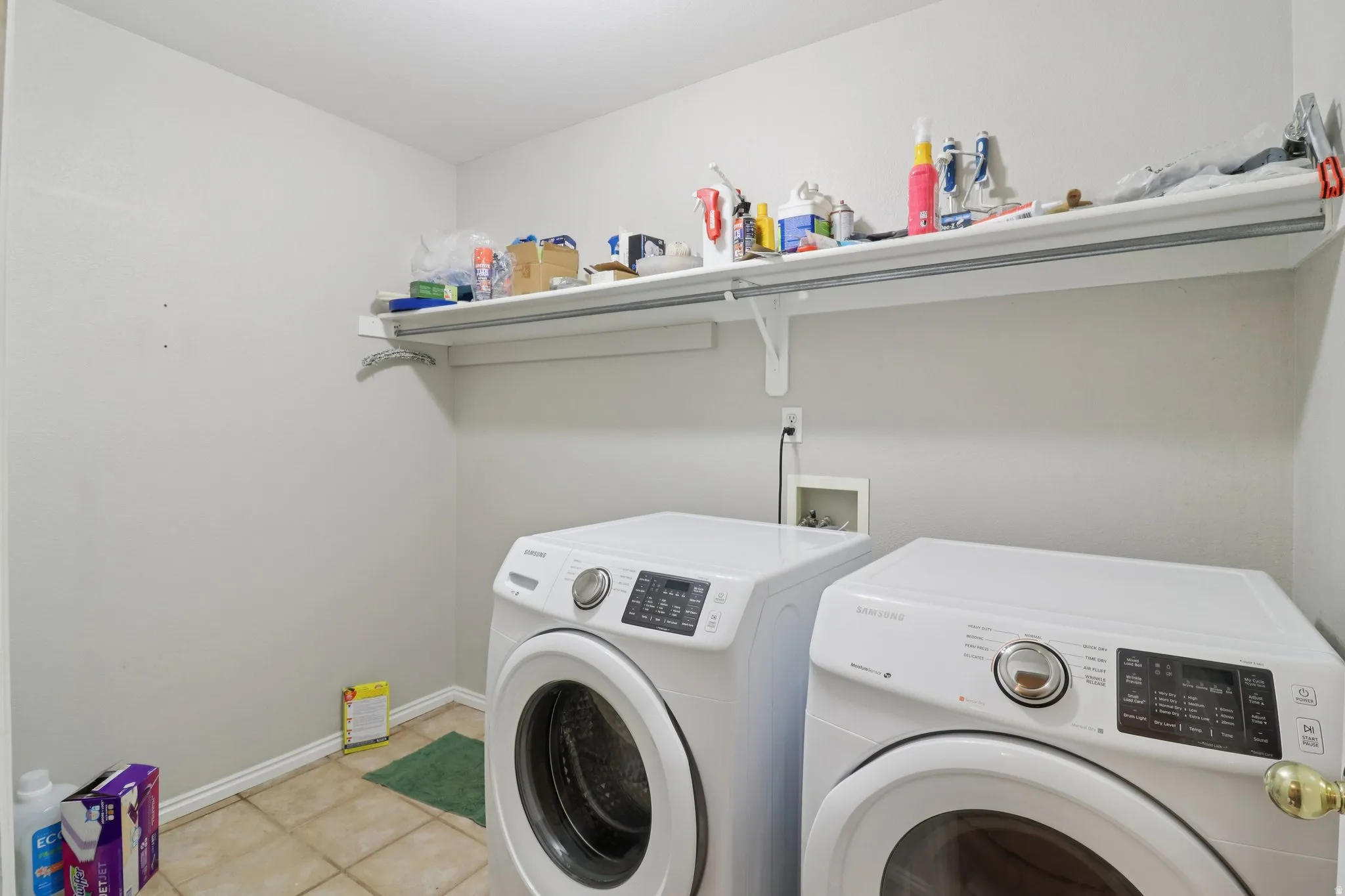 Laundry room with washer and dryer and light tile patterned floors