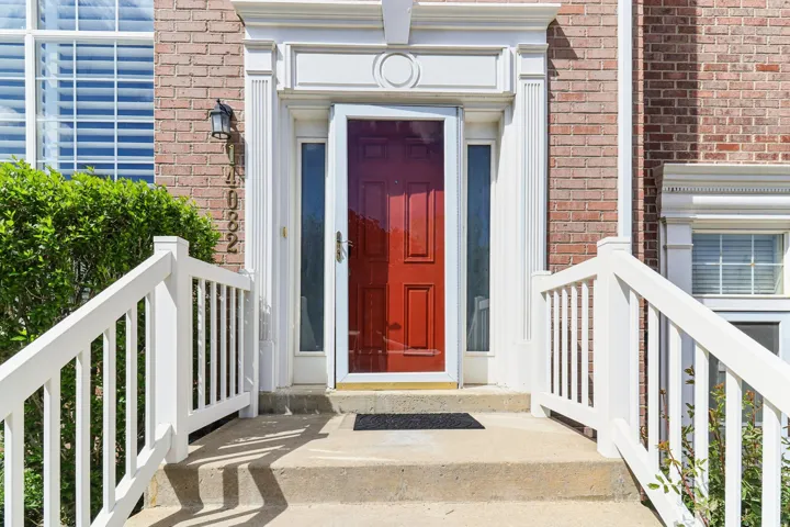 Entrance to property featuring brick siding