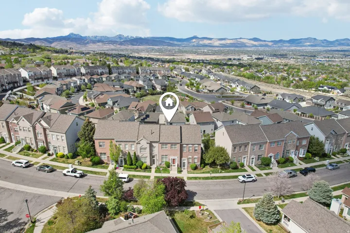 Aerial perspective of suburban area featuring a mountain backdrop