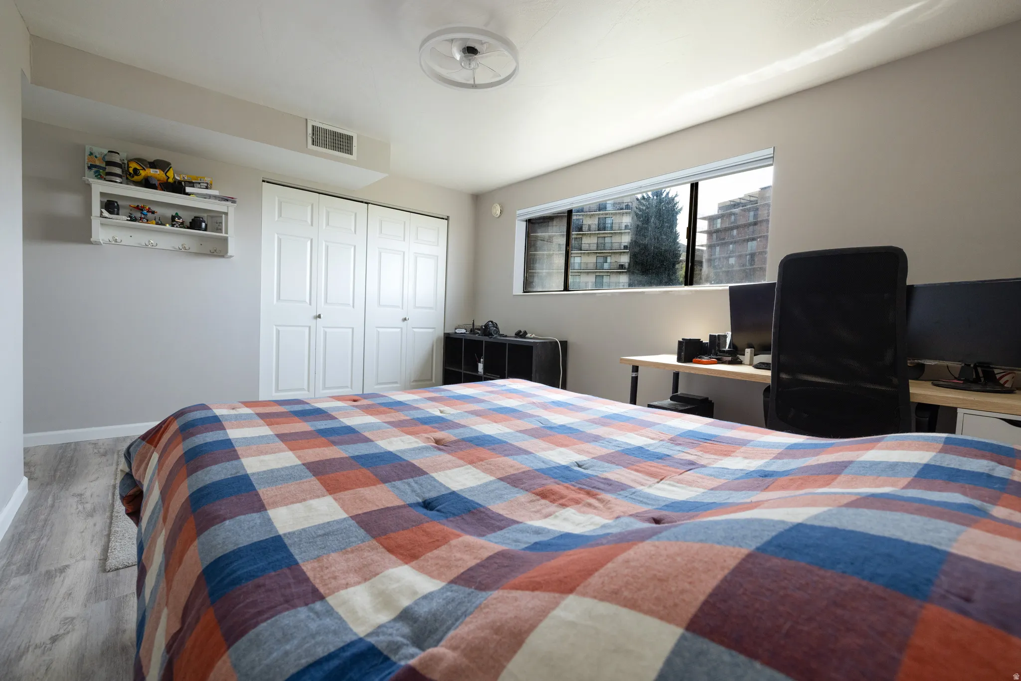 Bedroom featuring wood finished floors and a closet