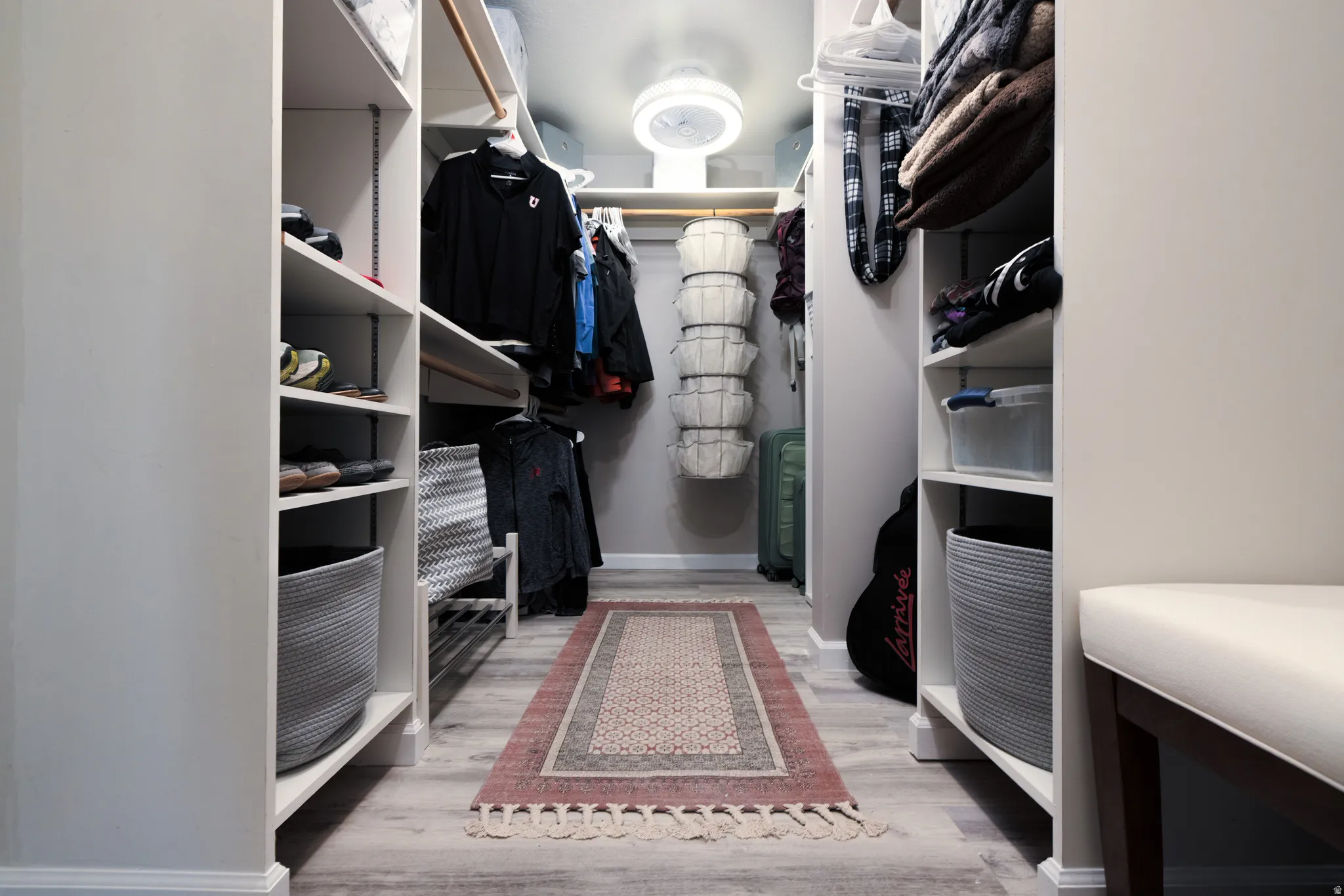 Primary Walk in closet featuring light wood-type flooring