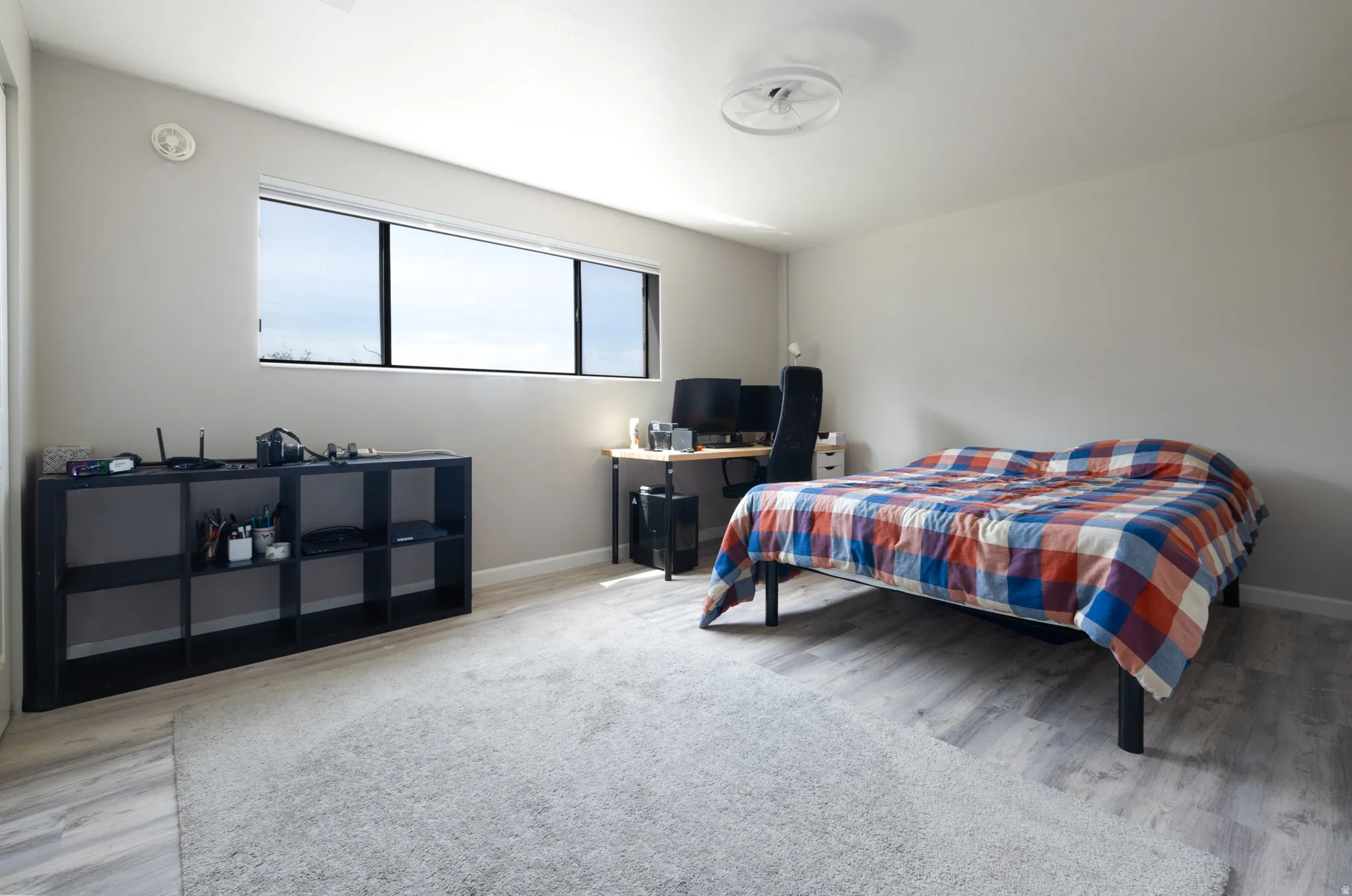 Bedroom with light wood-style floors and baseboards