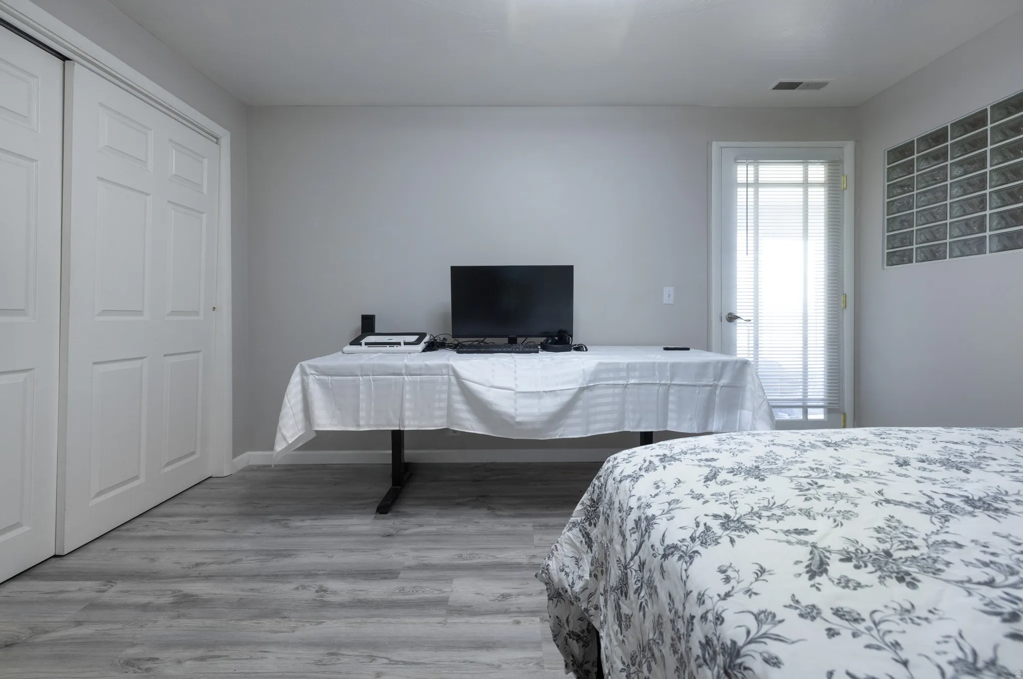 Bedroom featuring light wood finished floors and a closet