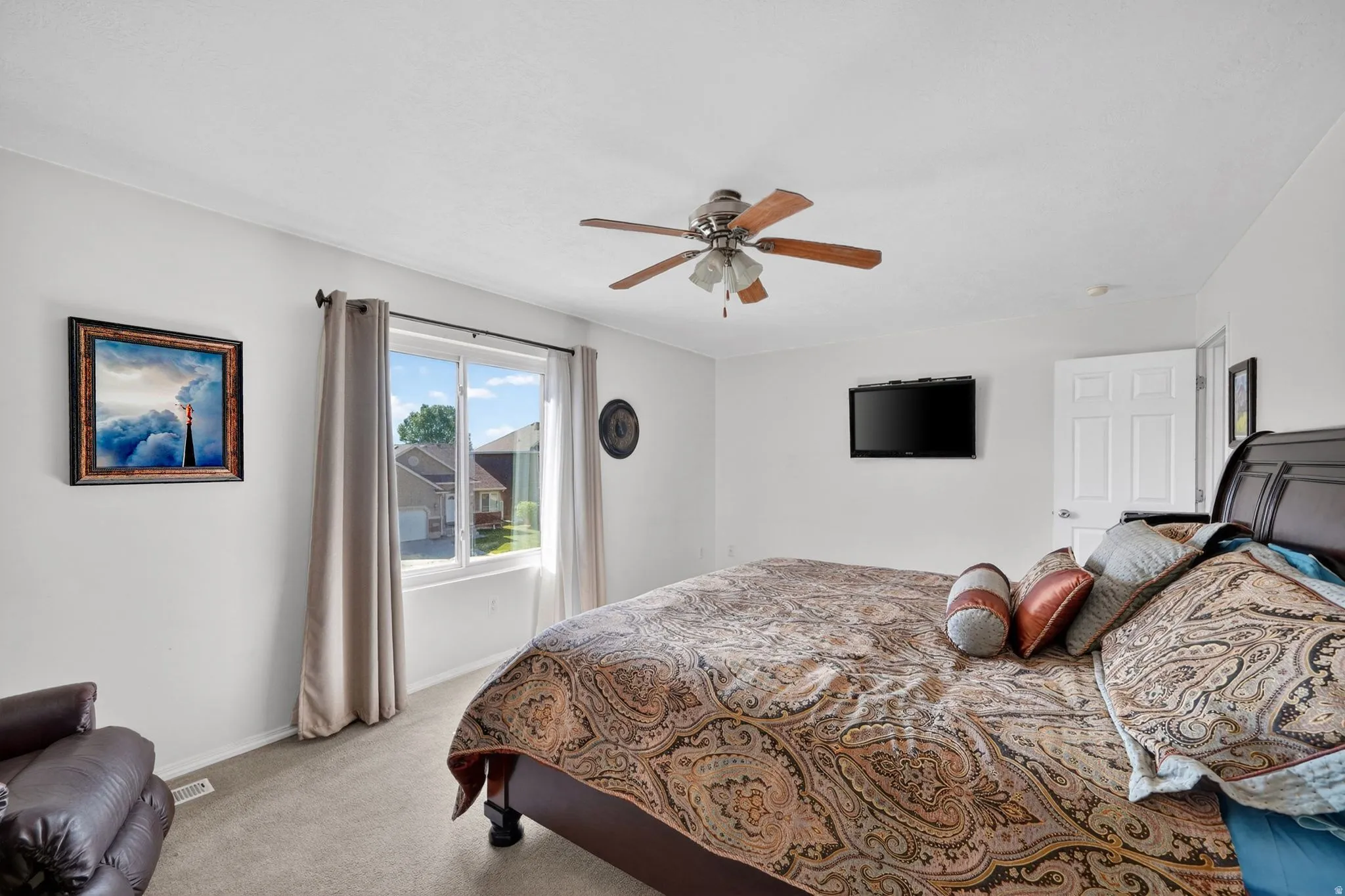 Bedroom featuring light colored carpet and ceiling fan
