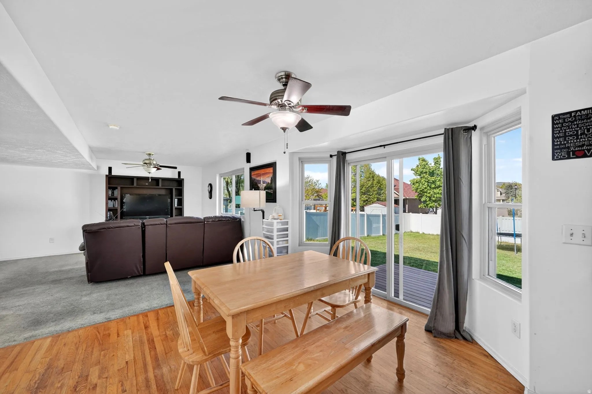 Dining space featuring light wood-style flooring, a ceiling fan, and plenty of natural light