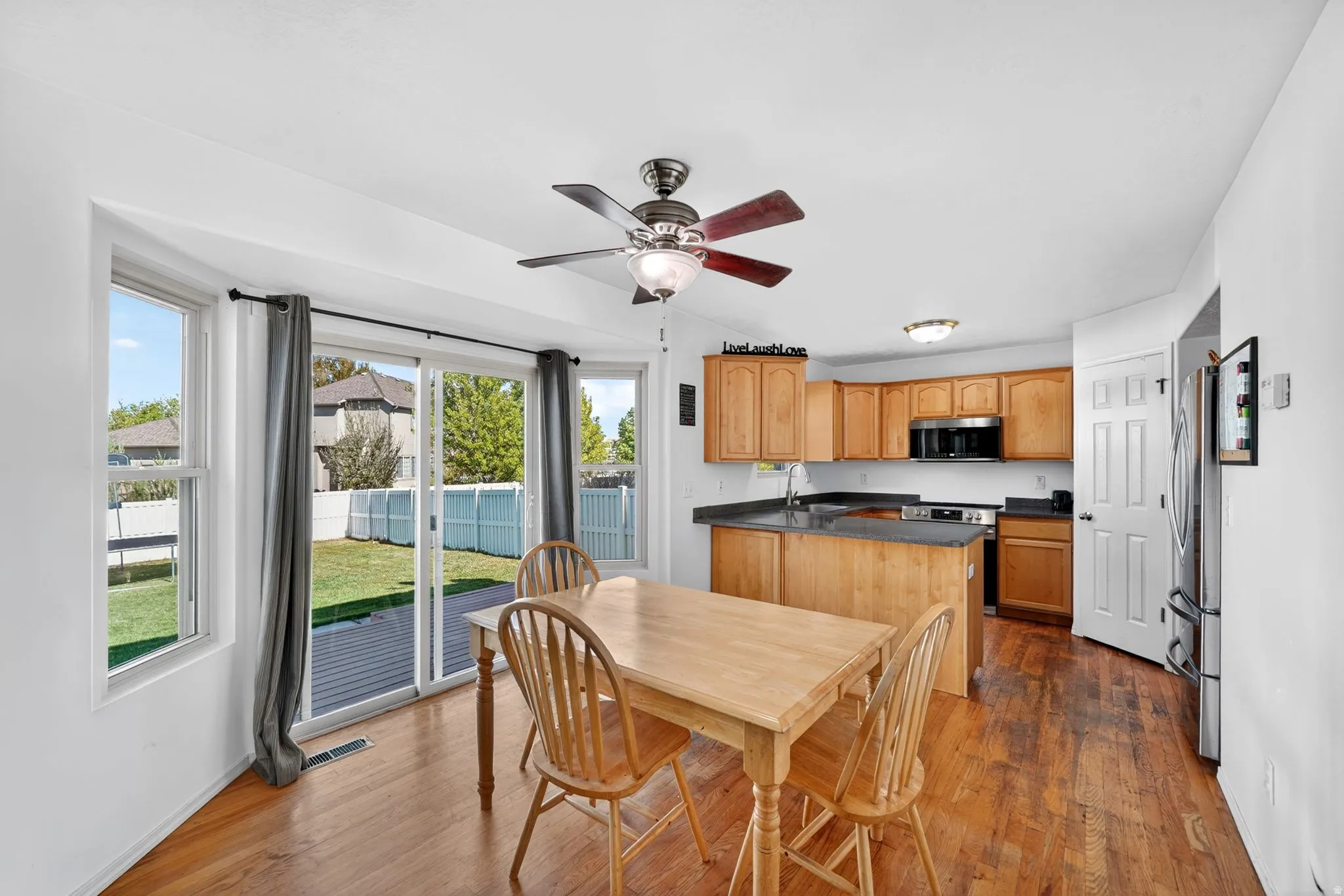 Dining area featuring a ceiling fan and dark wood finished floors