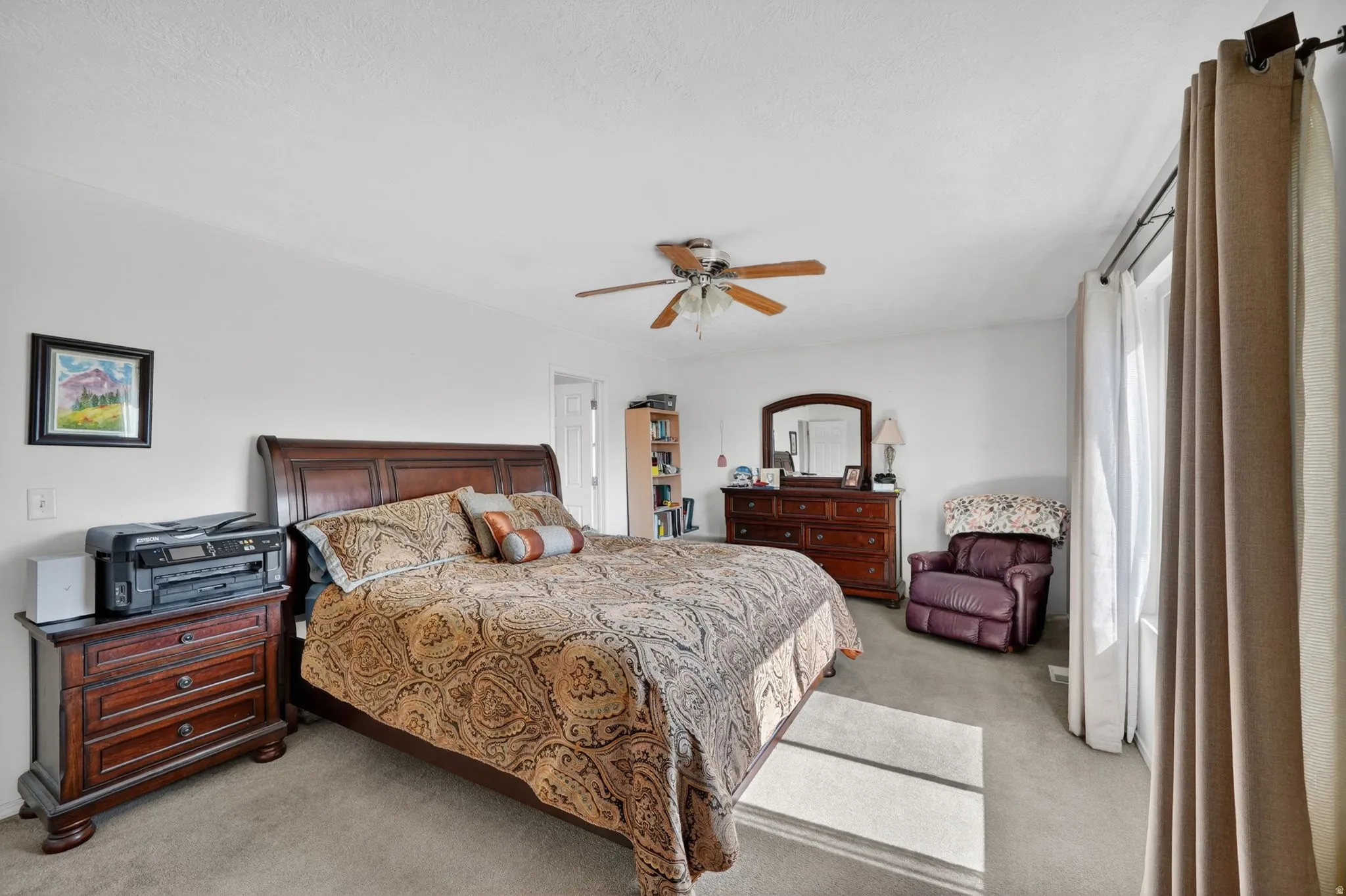 Bedroom featuring light carpet and ceiling fan