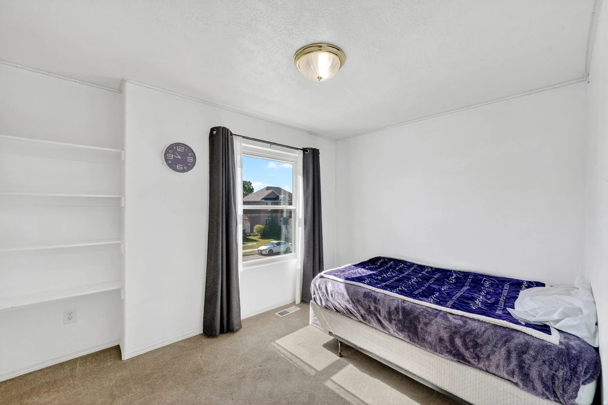 Bedroom featuring light carpet and baseboards