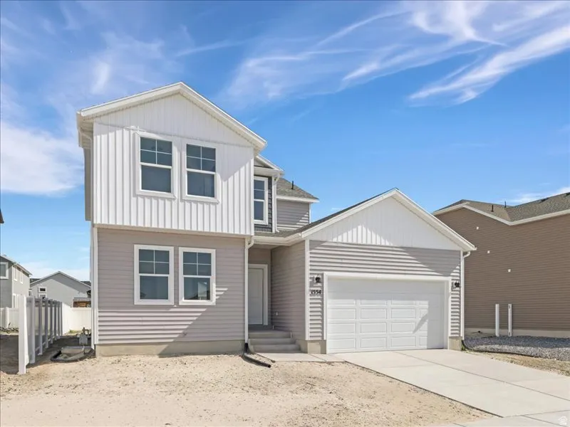 Two-story residence featuring light gray horizontal siding and white vertical siding accents