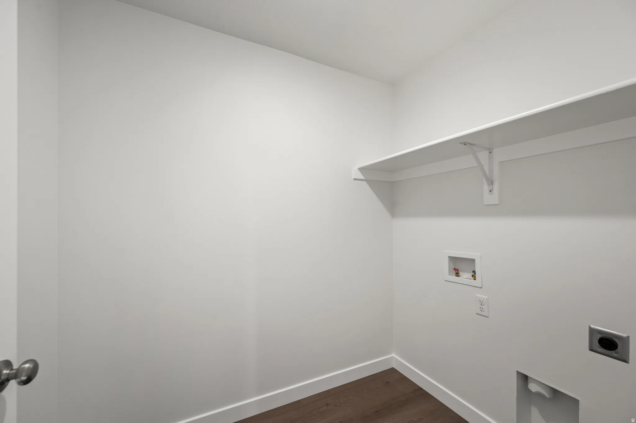 Laundry room featuring dark wood-style flooring, washer hookup, and hookup for an electric dryer