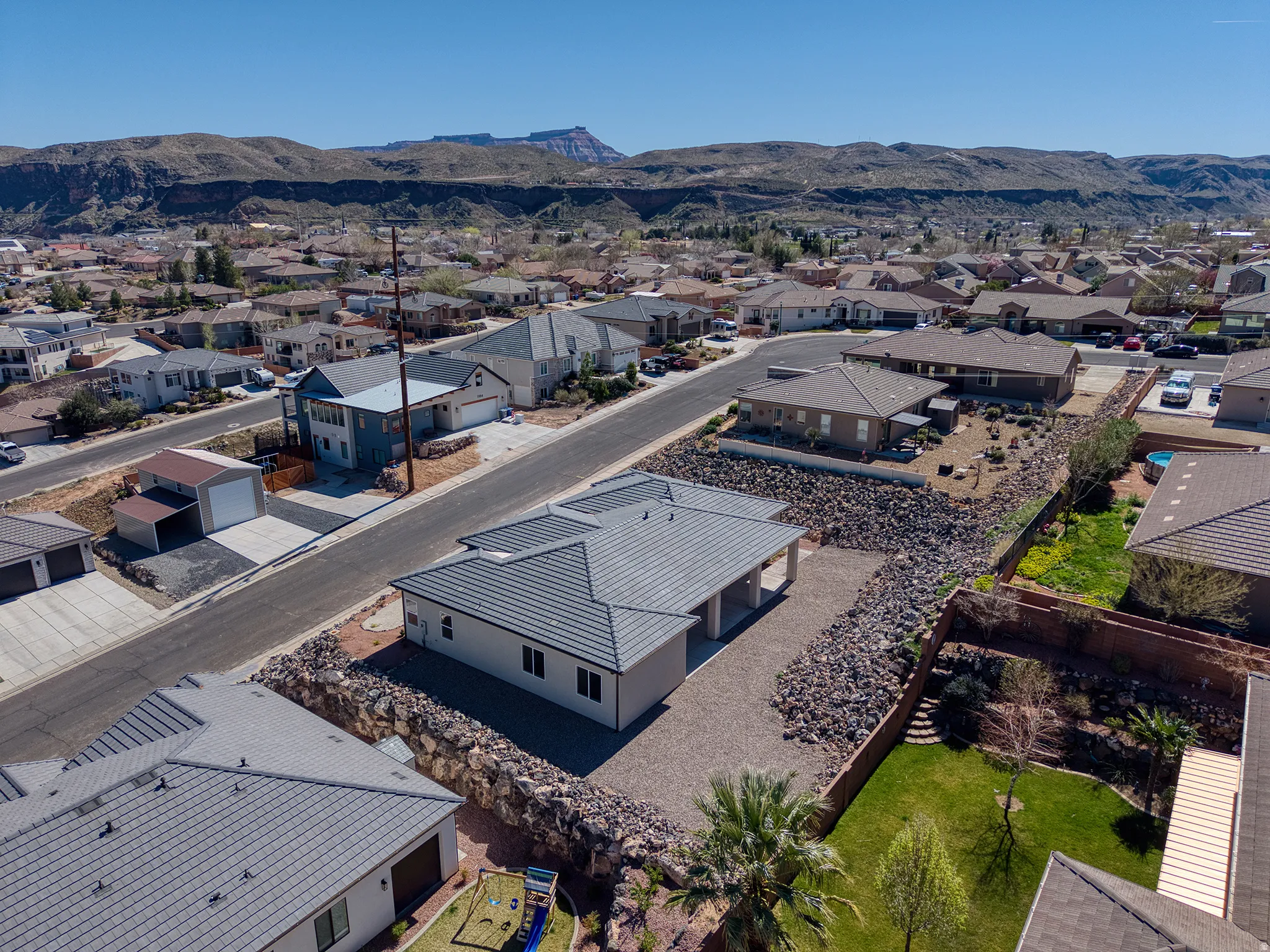 Aerial perspective of suburban area featuring a mountainous background
