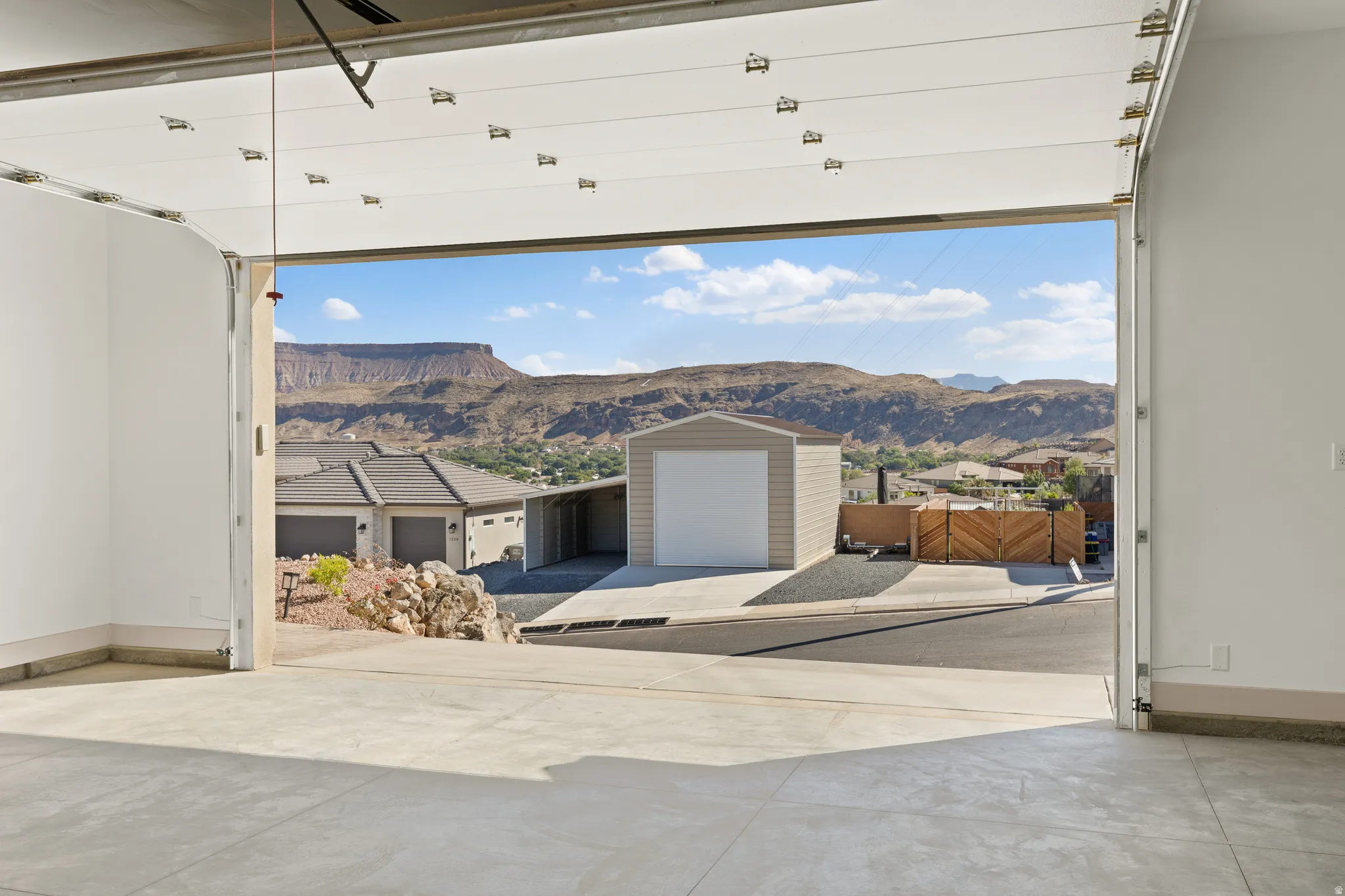 Garage with baseboards and a mountain view