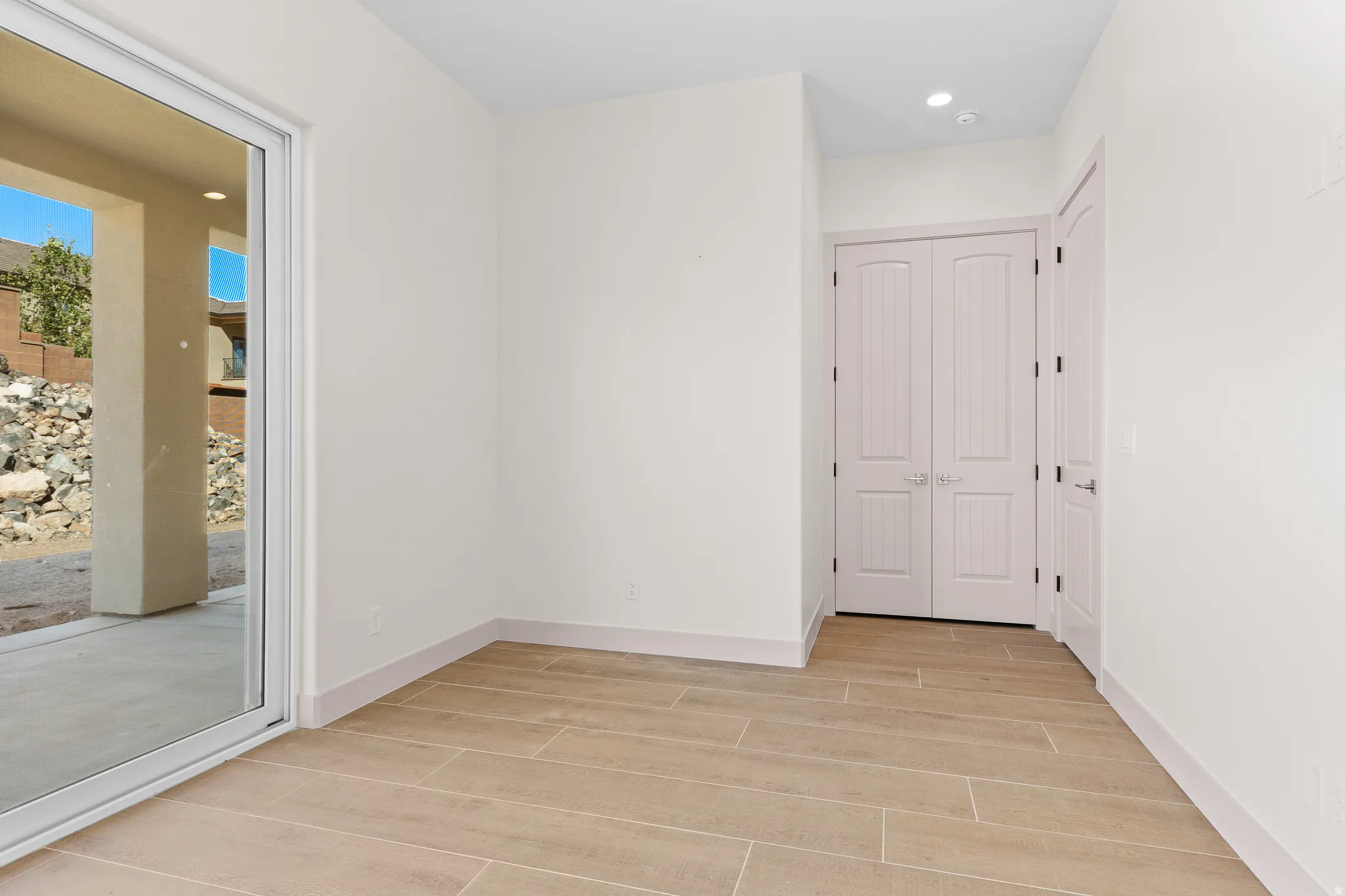 Spare room with wood tiled floors and recessed lighting