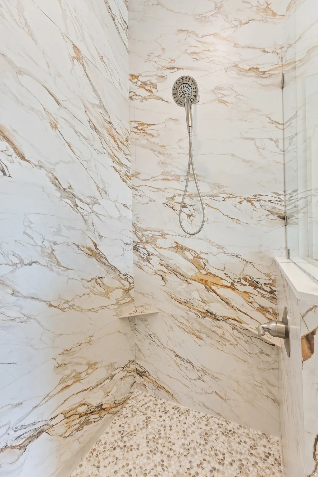 Bathroom with a marble finish shower