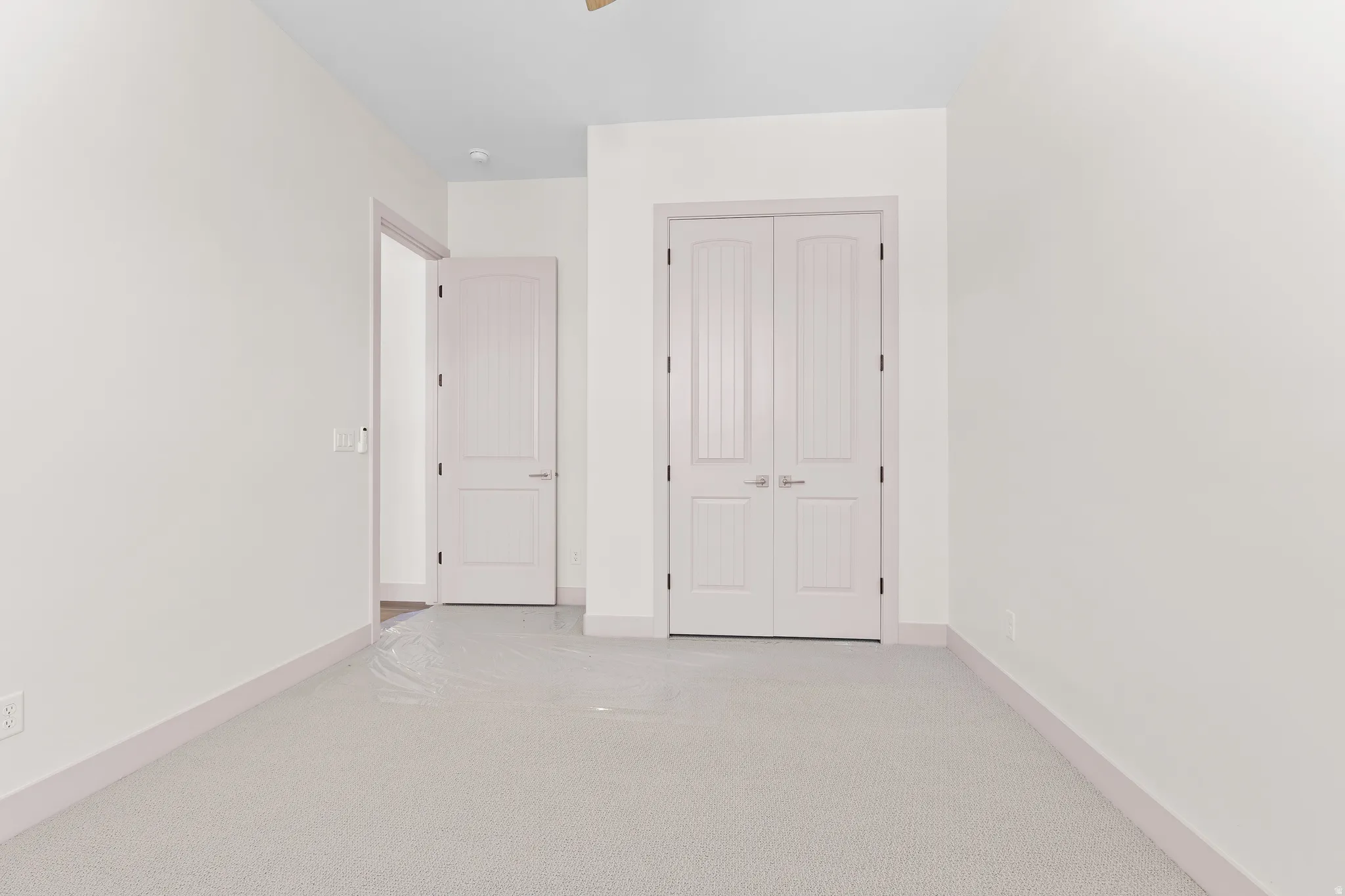 Unfurnished bedroom featuring a closet and light carpet