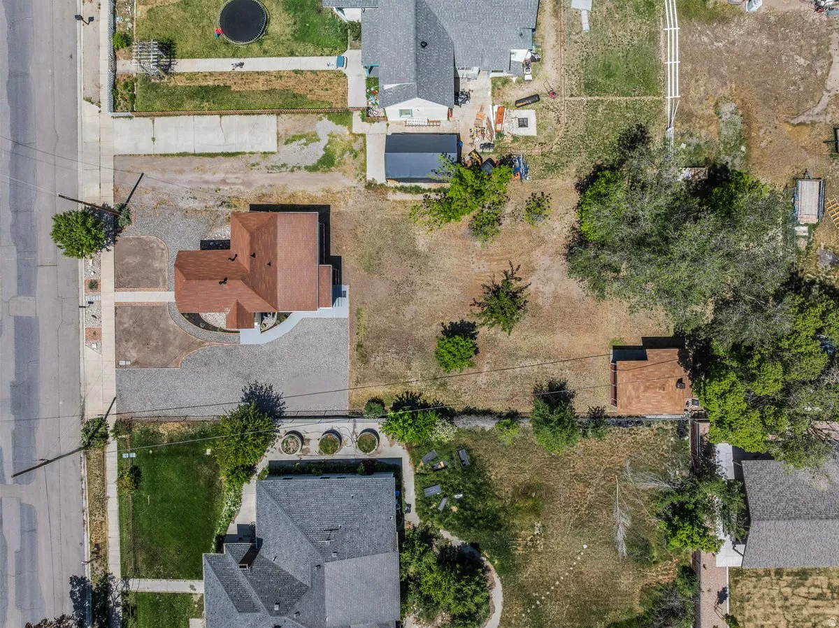 Aerial perspective highlighting a property with a brown-shingled roof