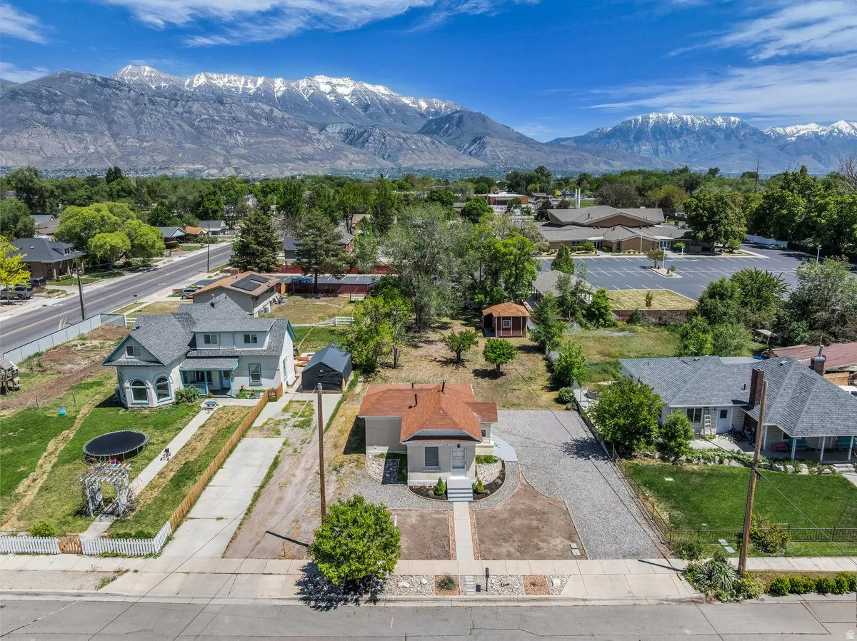 Aerial perspective showcasing multiple properties with snow-capped mountains in the background