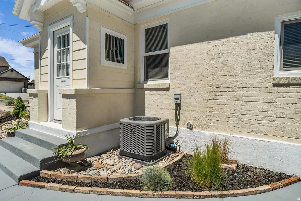 Exterior siding featuring horizontal panels and a painted brick foundation
