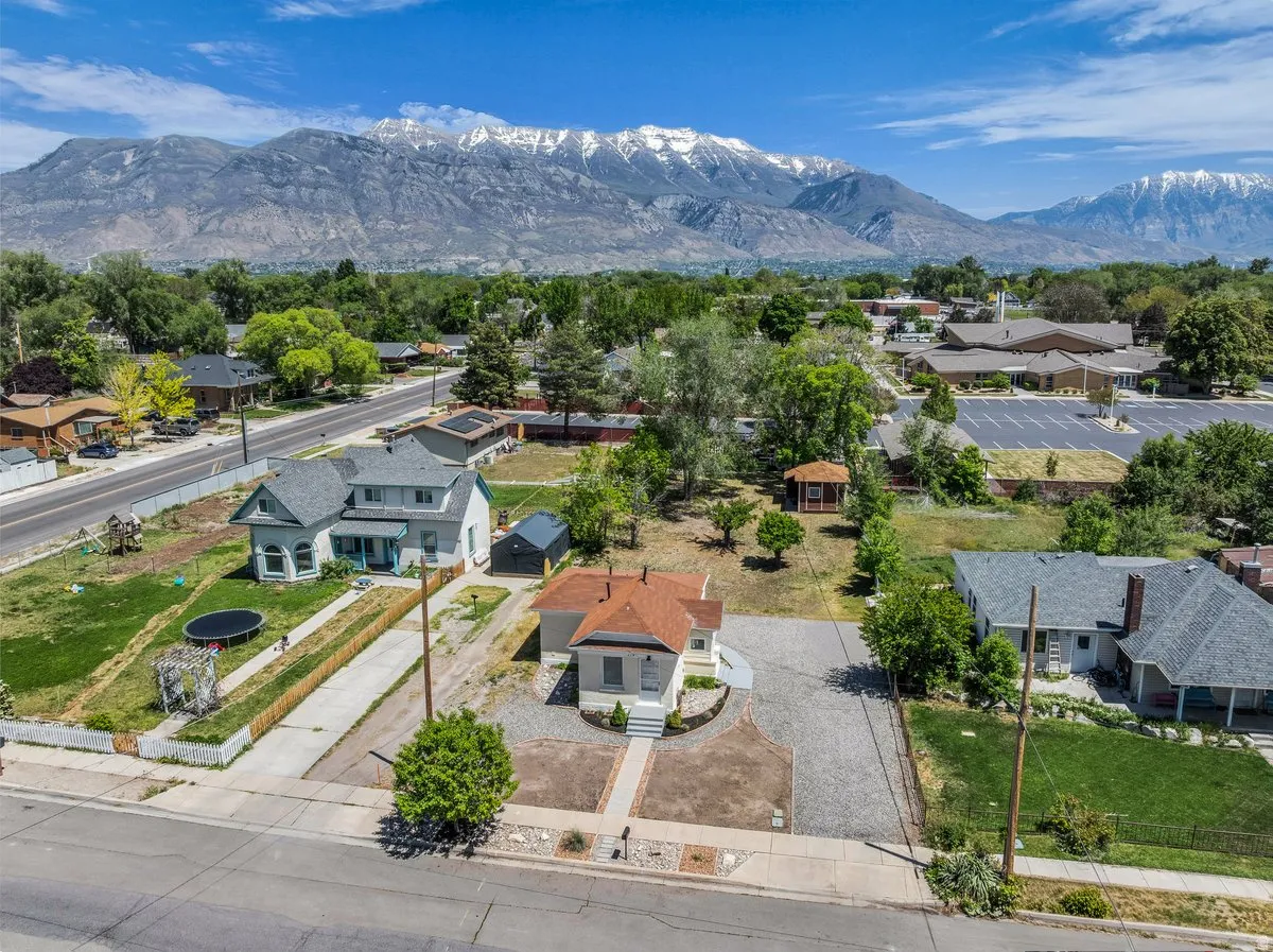 Aerial perspective showcasing surrounding properties and distant snow-capped mountains