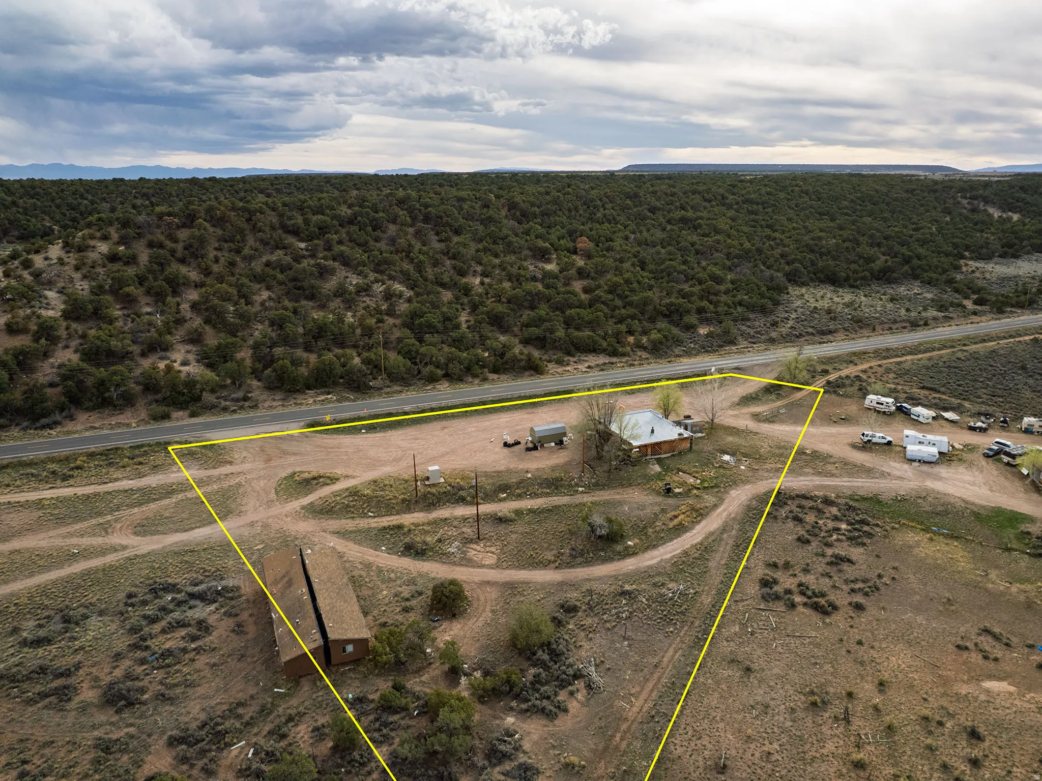 Rustic-style cabin on an expansive, arid lot with surrounding natural terrain