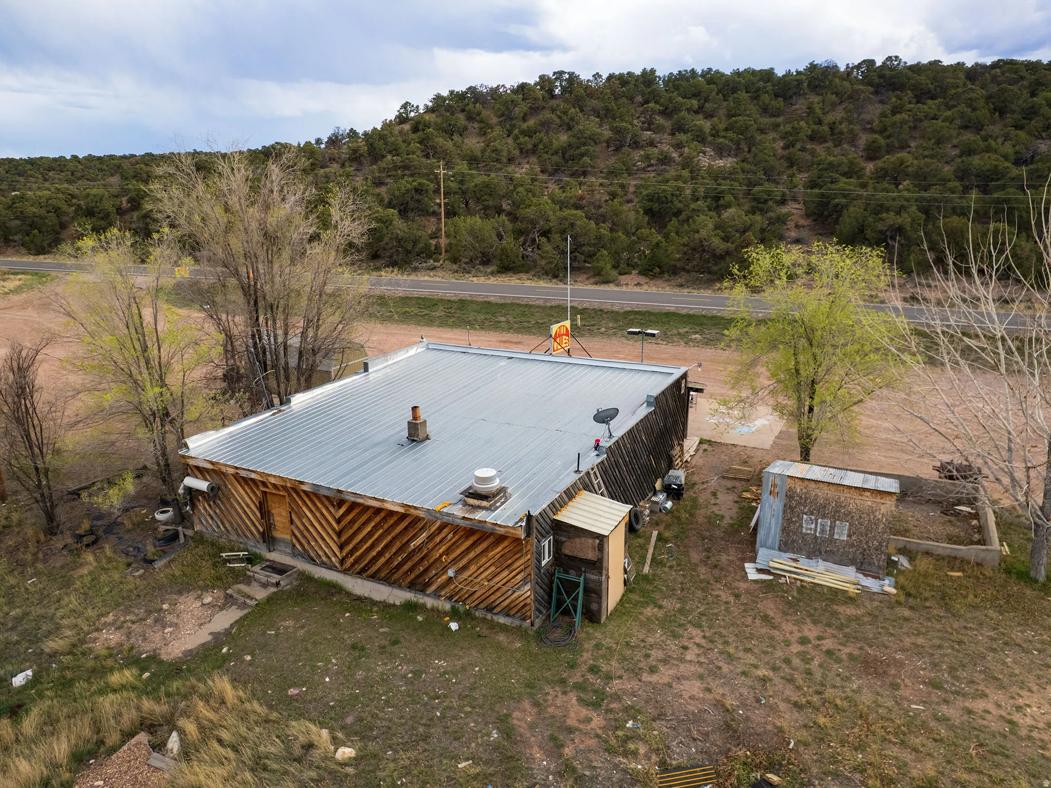 Building with wood siding and a metal roof