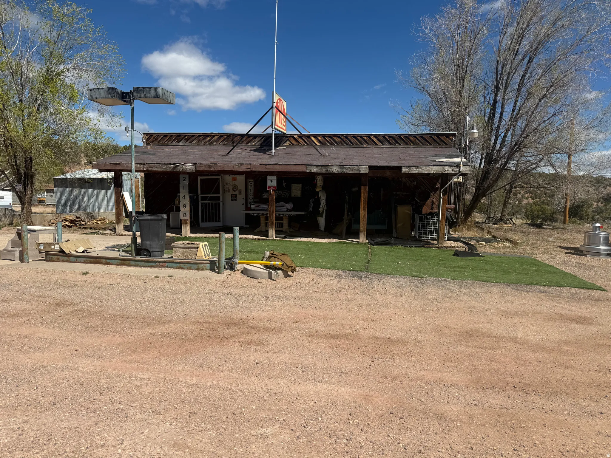Commercial structure with a covered front porch featuring exposed support beams