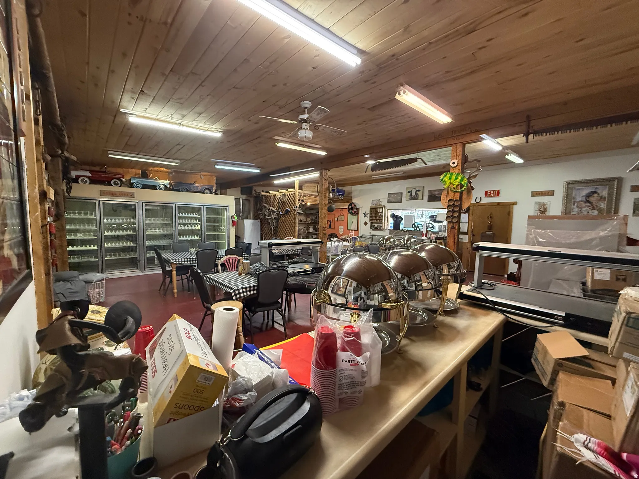 Commercial space with tongue-and-groove wood ceiling, recessed lighting, and exposed wood beams