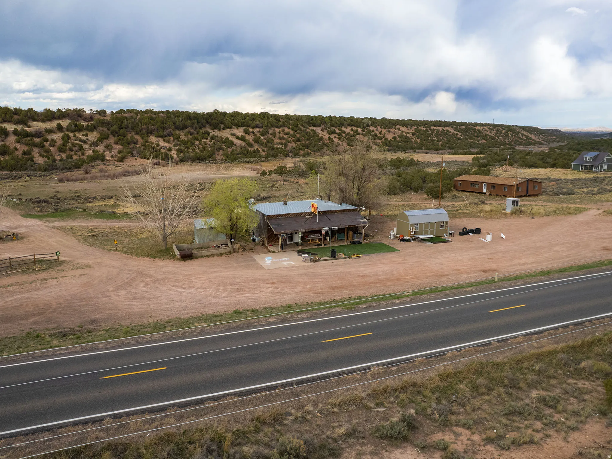 Rural property featuring a single-story dwelling with an extended covered porch and a metal roof