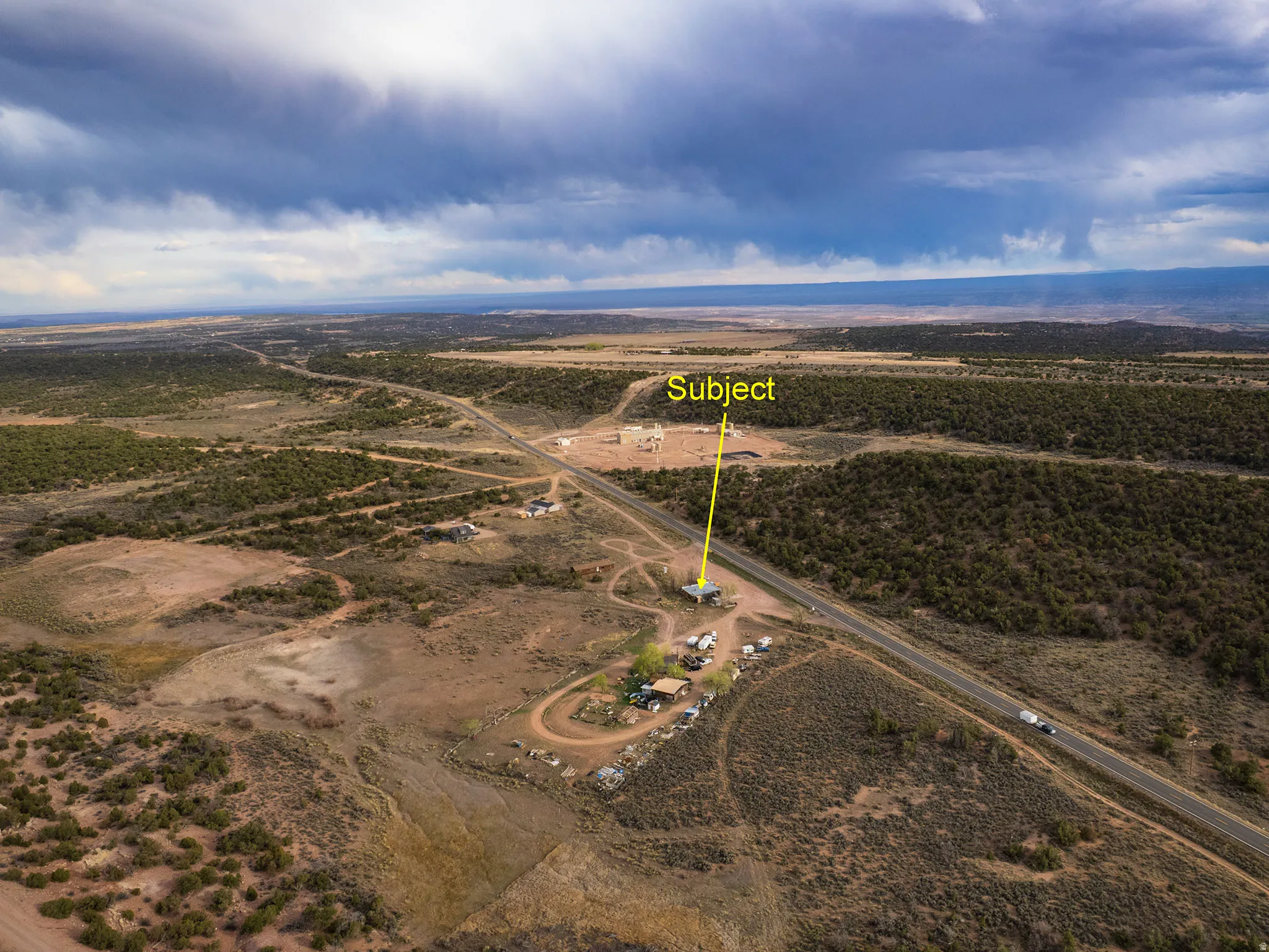 Expansive aerial perspective showcasing the subject property with direct road frontage