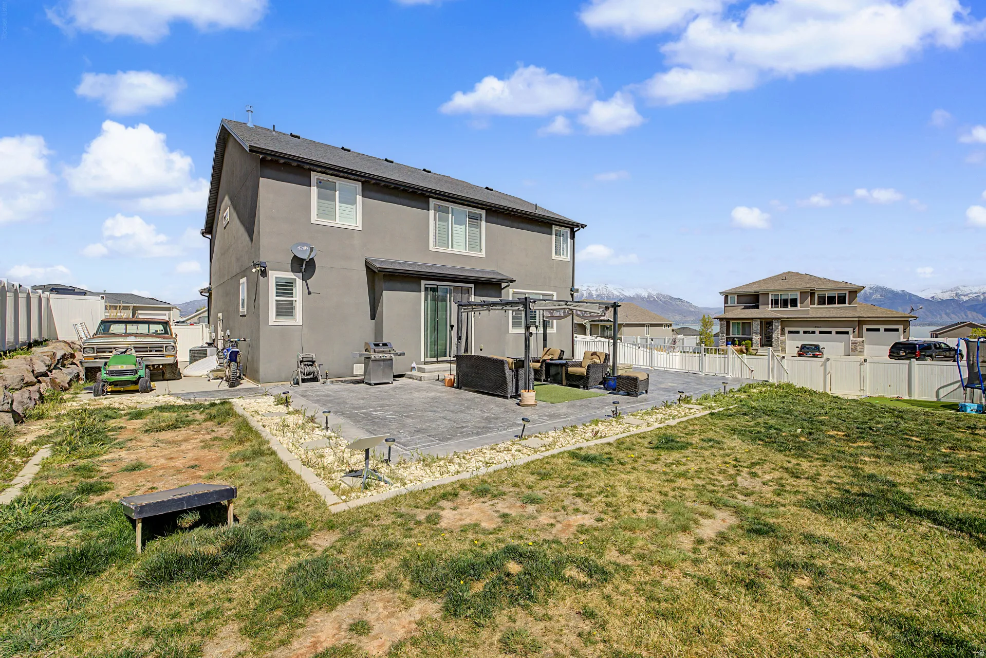 Back of house featuring a patio, stucco siding, a fenced backyard, and a mountain view