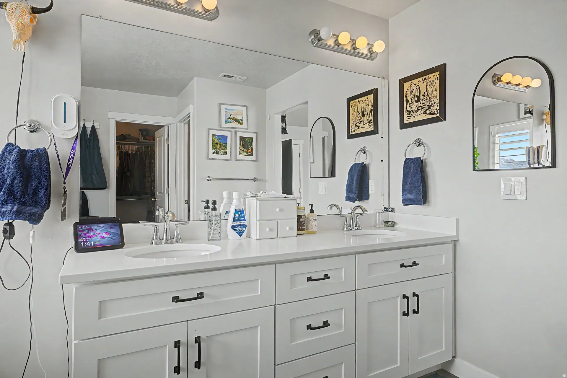 Bathroom featuring double vanity and baseboards