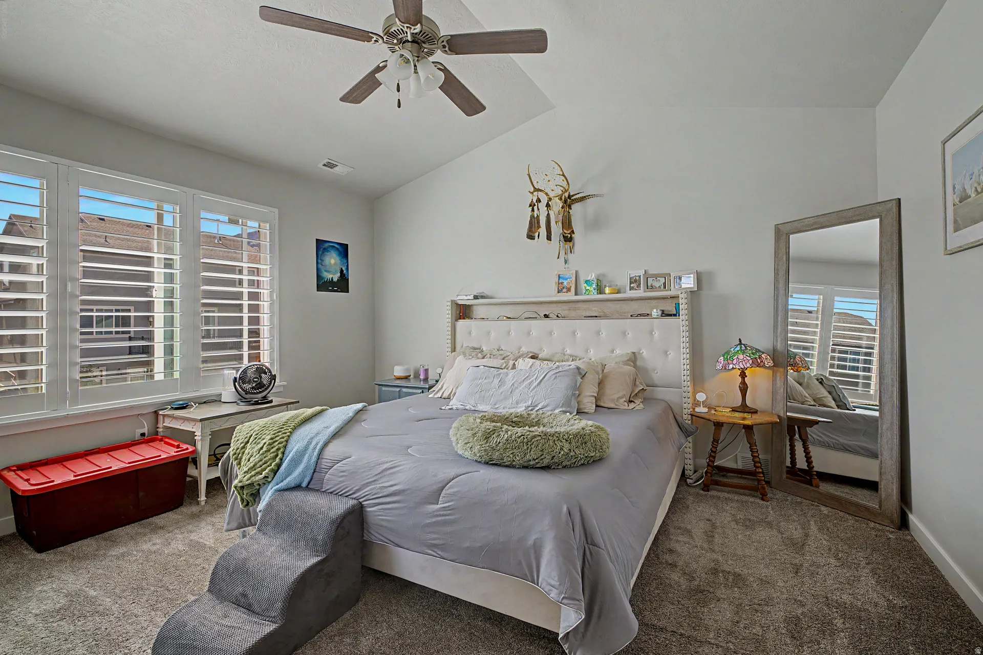 Bedroom with lofted ceiling, carpet flooring, and a ceiling fan