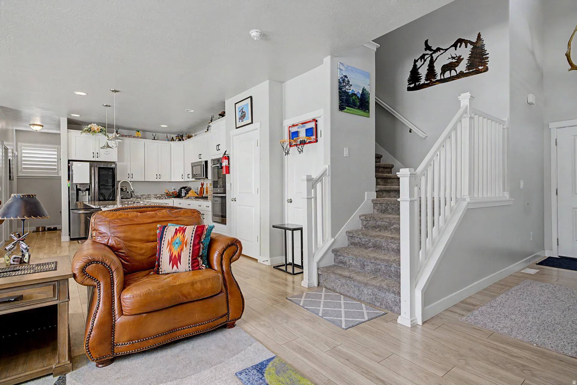 Living area with stairs and light wood-style floors