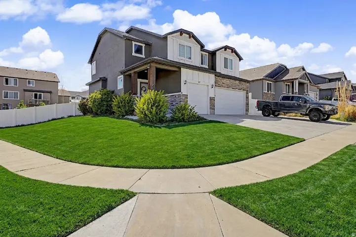 AI enhanced View of front of home featuring stone siding, a garage, a residential view, and concrete driveway