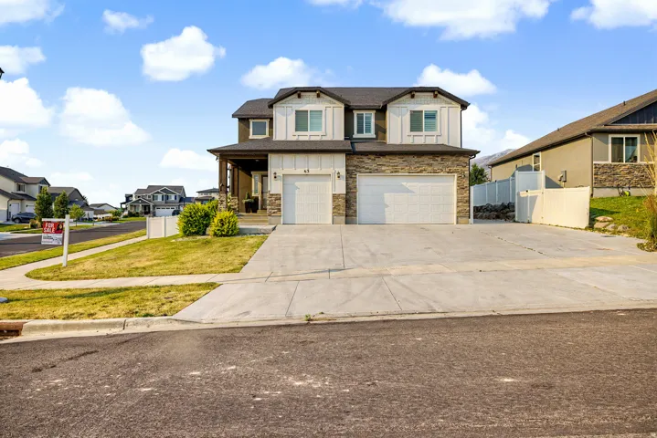 Contemporary multi-level exterior featuring light-colored siding and dark trim accents