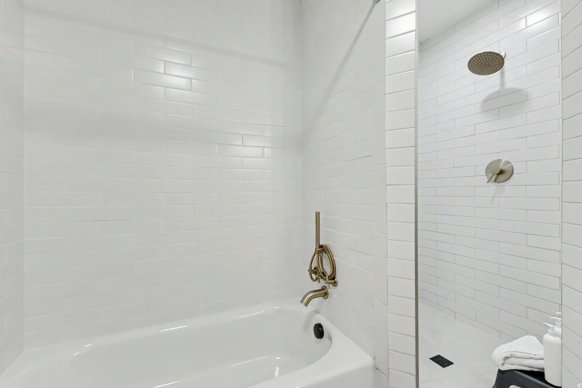 Bathroom with tiled shower and a garden tub