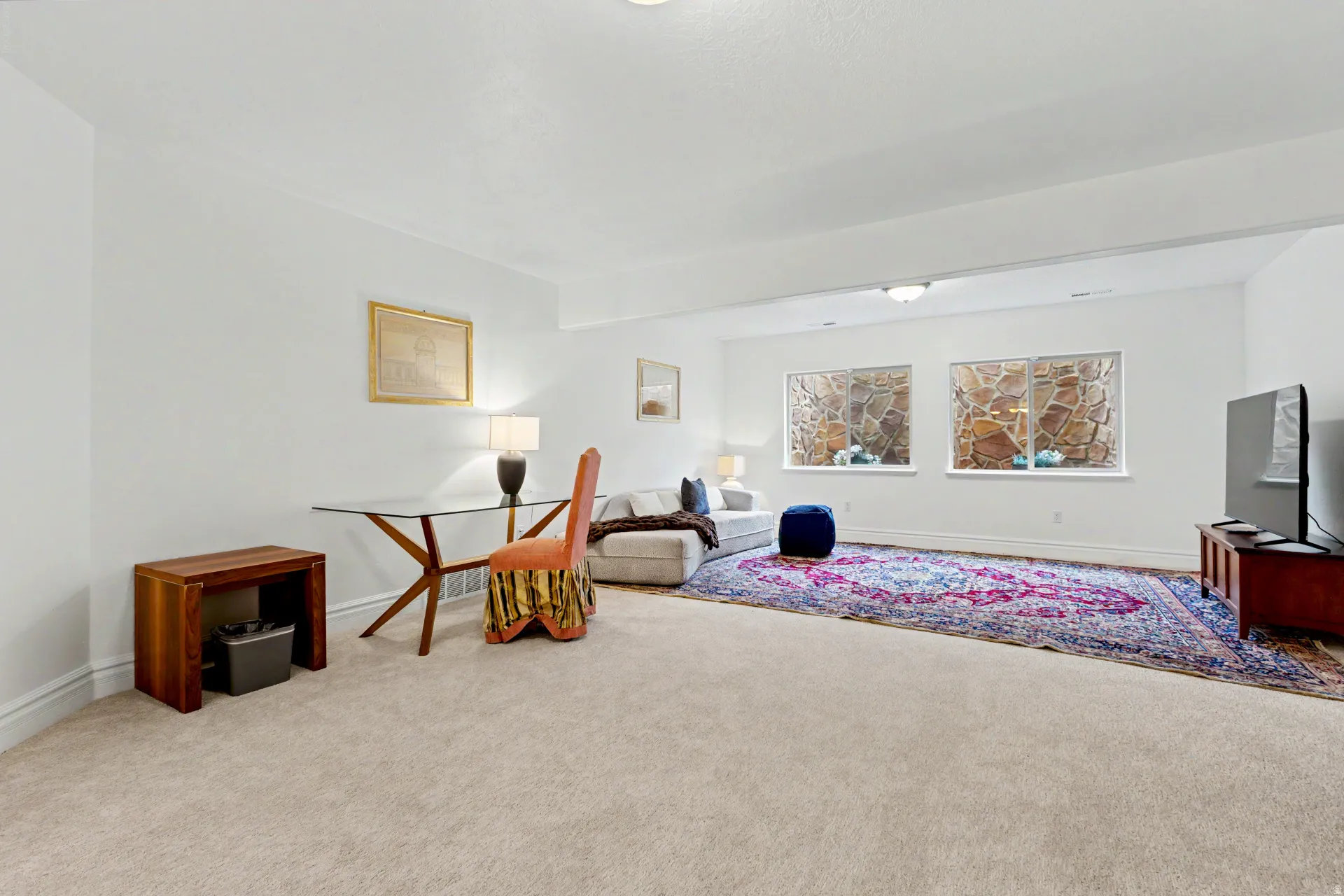Sitting room with carpet floors and baseboards