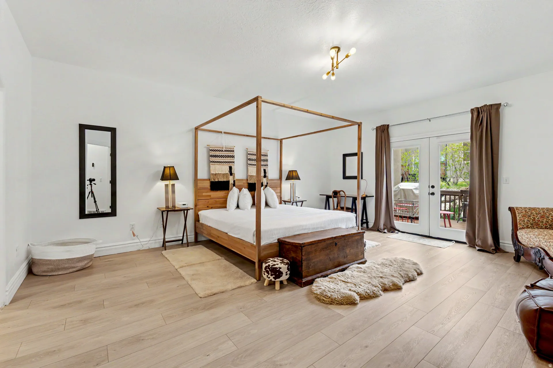 Bedroom with french doors, access to exterior, and light wood-type flooring