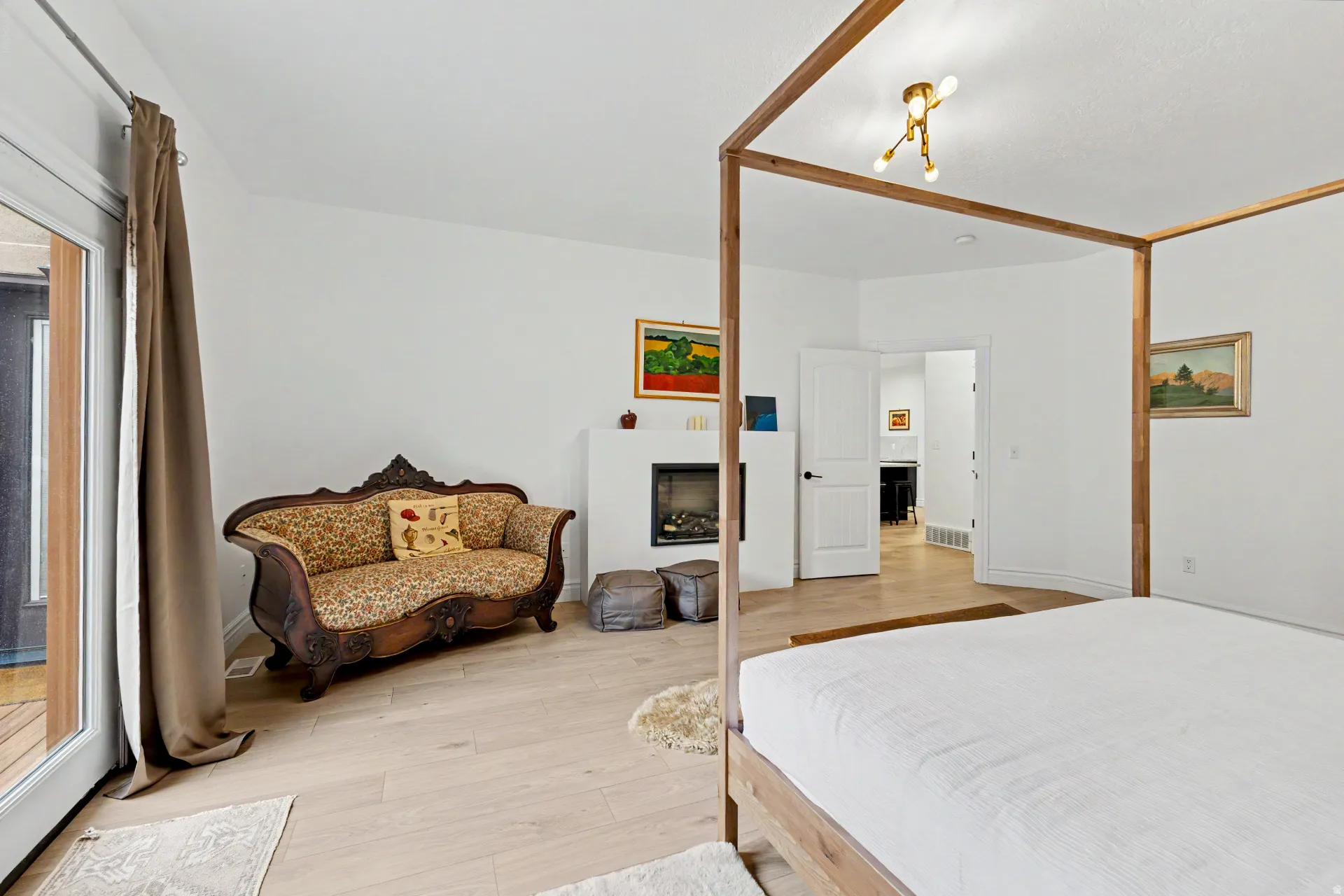 Bedroom with light wood-type flooring and a fireplace
