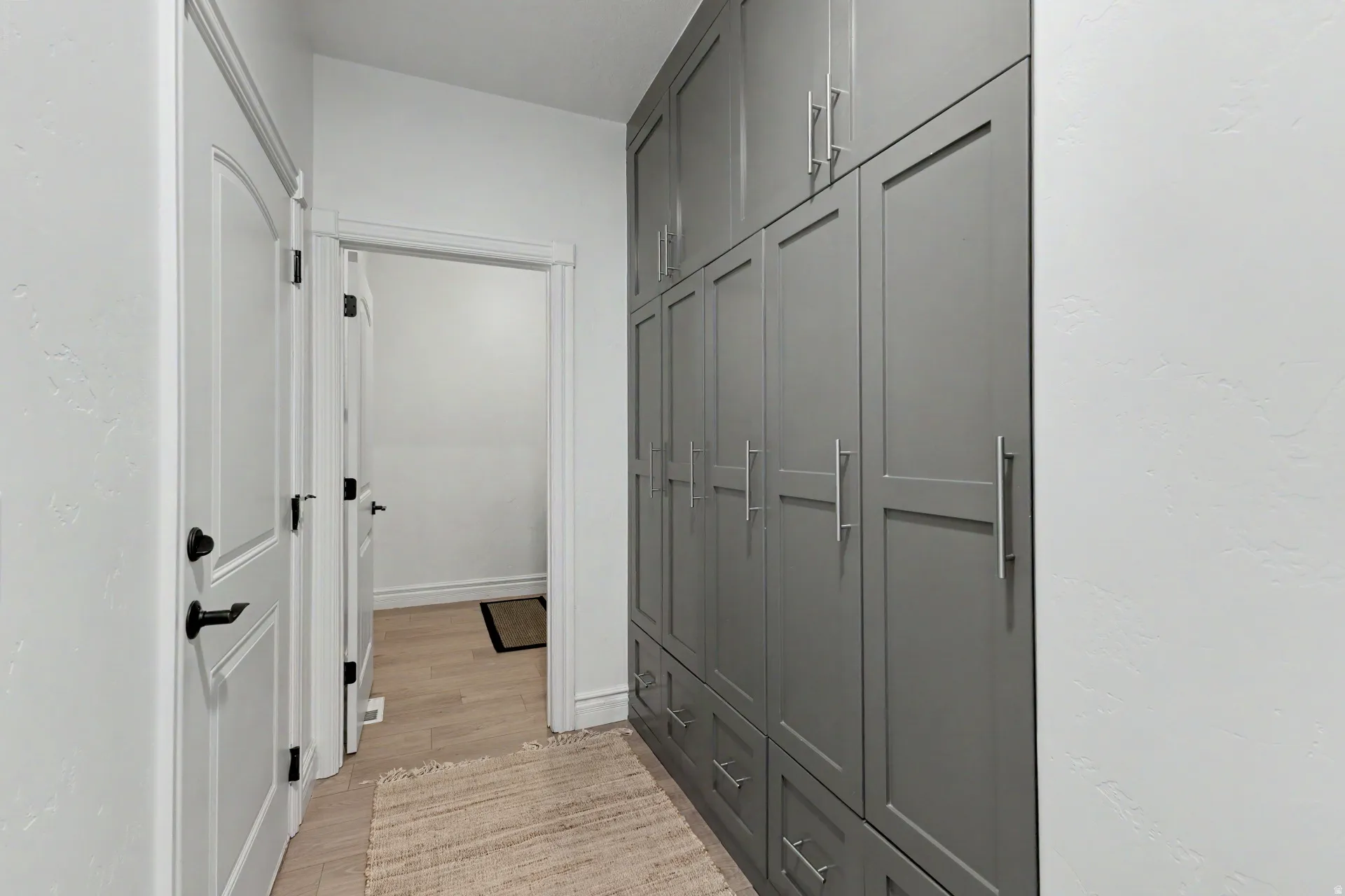 Hall with light wood finished floors