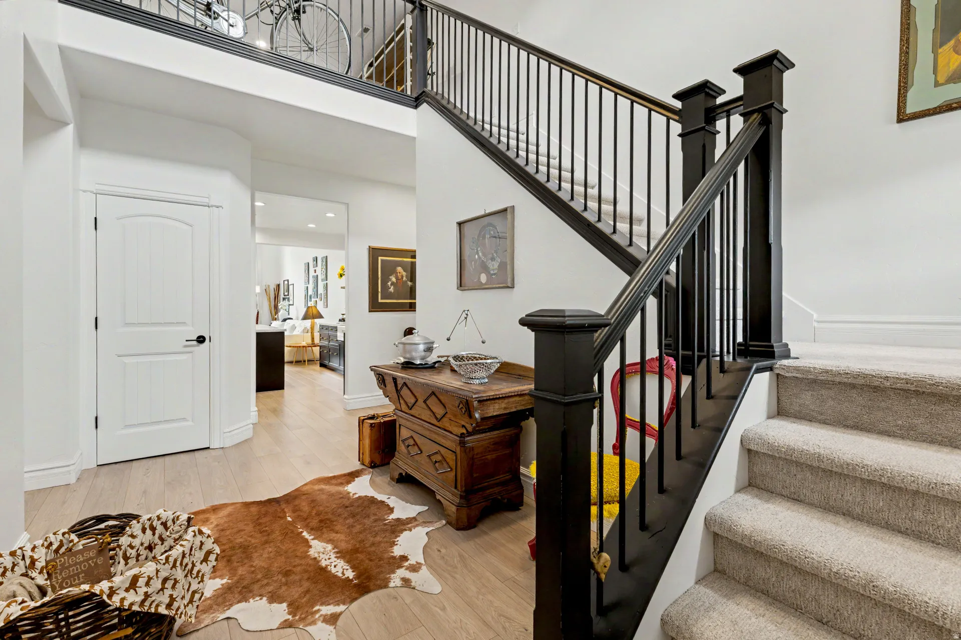 Stairs featuring hardwood / wood-style flooring and a high ceiling