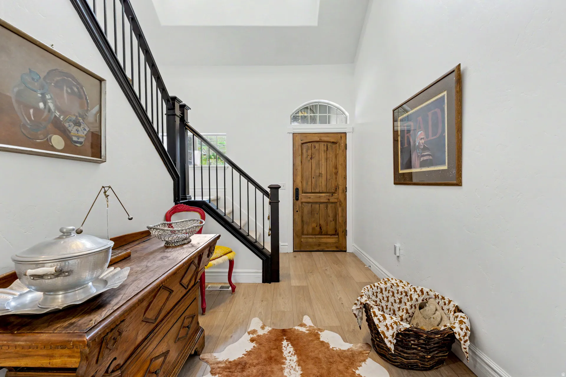 Entryway featuring light wood-style floors and a high ceiling