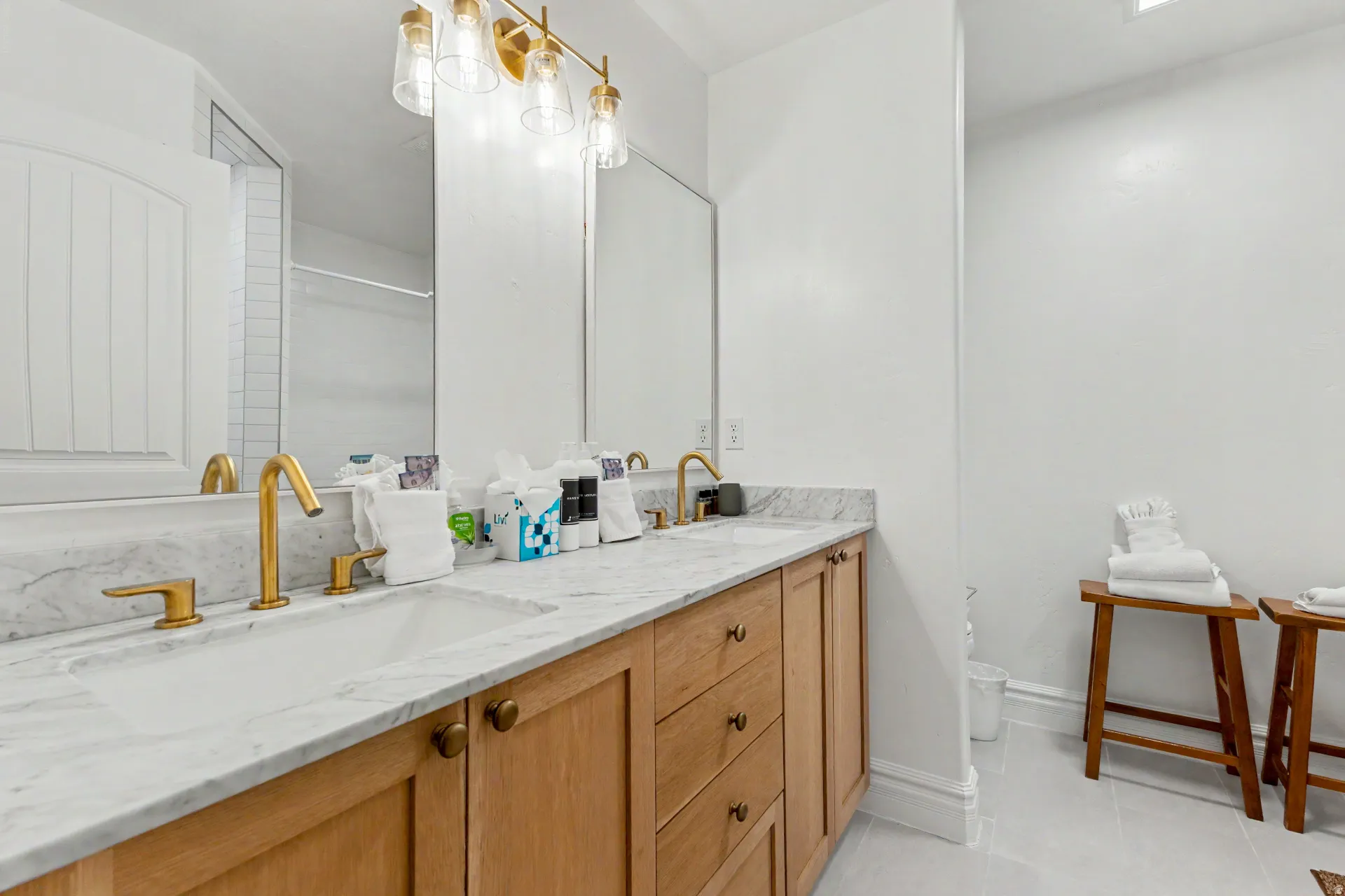 Full bathroom with double vanity and light tile patterned flooring