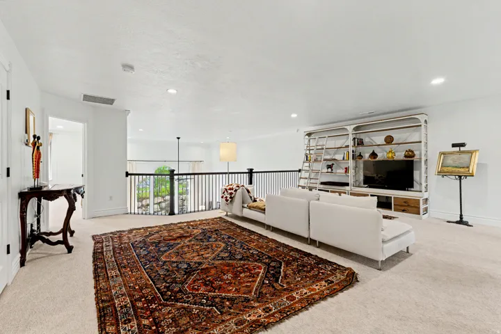 Living room featuring light colored carpet and recessed lighting