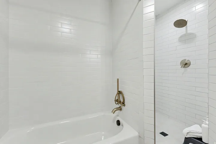 Bathroom with tiled shower and a garden tub